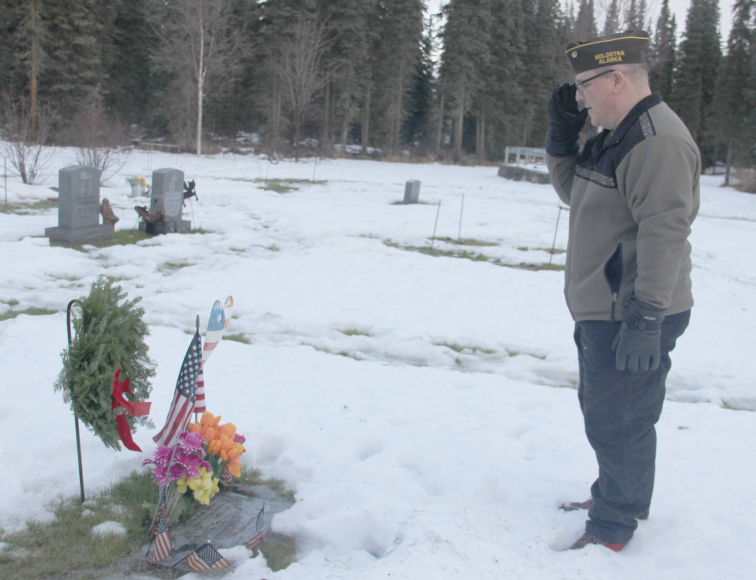 John Walker, Commander Jerry V. Horn Memorial Post 10046 VFW places a wreath on a veteran’s grave in Soldotna.