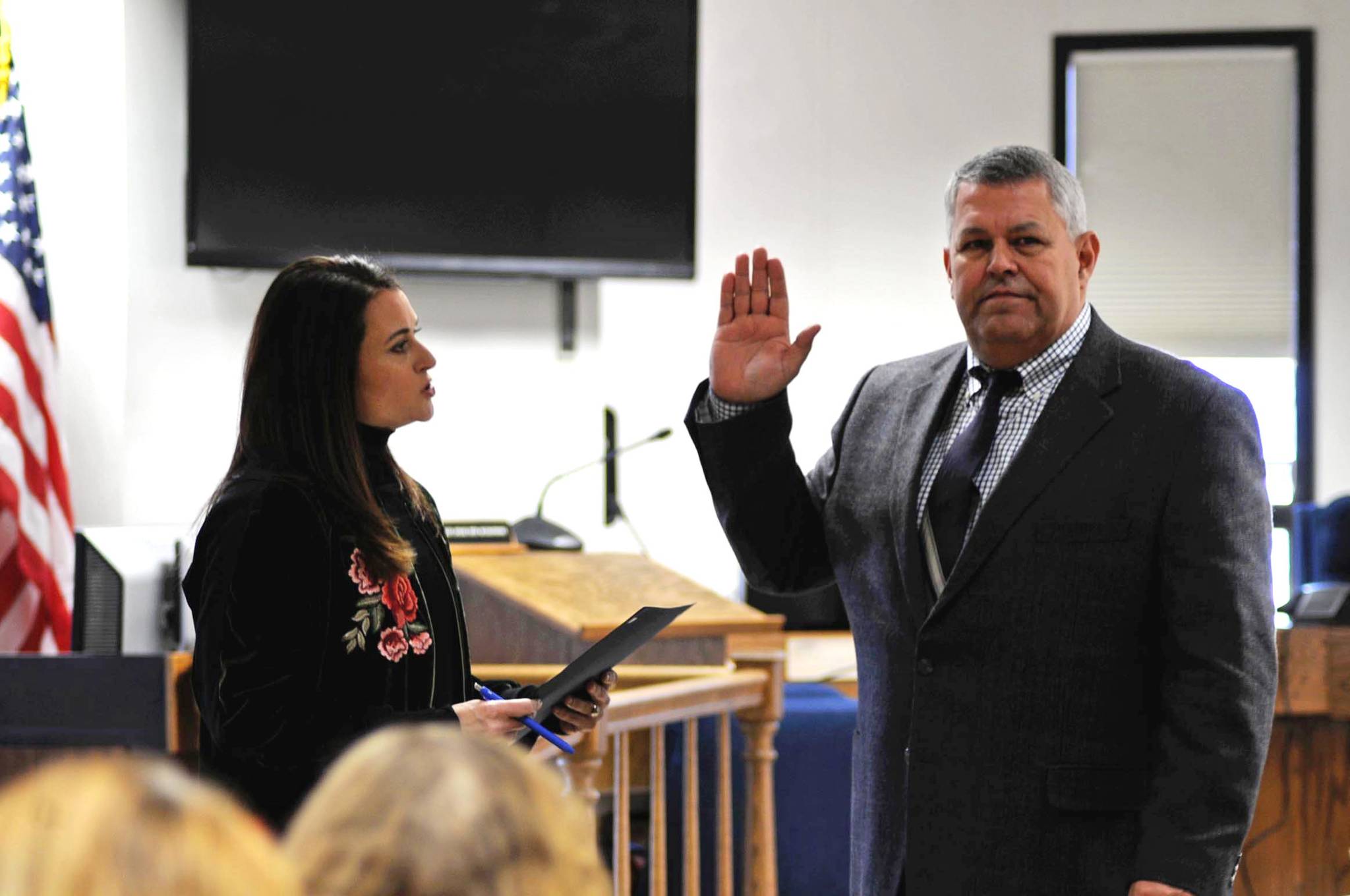 Borough Clerk Johni Blankenship (left) administers the oath of office to Borough Mayor Charlie Pierce during a swearing-in ceremony at the George A. Navarre Borough Administration Building on Monday, Nov. 6, 2017 in Soldotna, Alaska. Pierce won the mayor’s seat in a runoff election held Oct. 24, narrowly defeating opponent Linda Hutchings with a margin of 45 votes. (Photo by Elizabeth Earl/Peninsula Clarion)