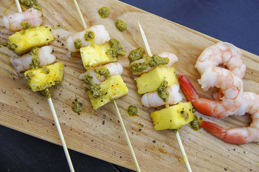 This Dec. 26, 2017 photo shows shrimp and pineapple skewers in Bethesda, Md. A super easy go-to recipe, which uses easy pantry ingredients, you can even use canned pineapple, to create something that still feels high-end.(Melissa daArabian via AP)