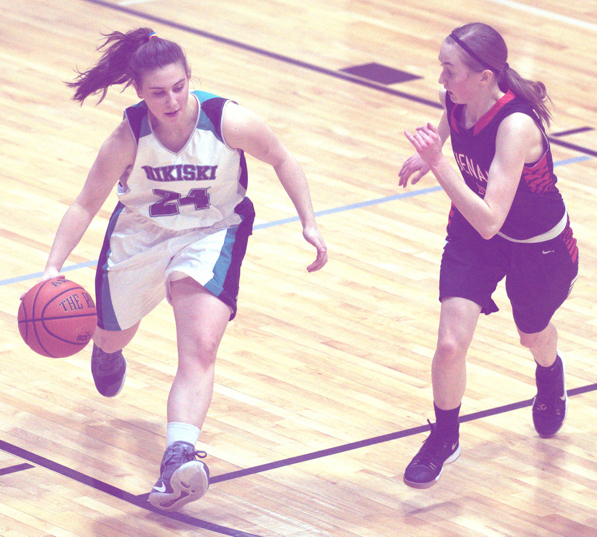 Nikiski’s Kelsey Clark brings the ball up the court against Kenai Central’s Jaycie Calvert on Thursday, Jan. 4, 2017, at Nikiski High School. (Photo by Jeff Helminiak/Peninsula Clarion)