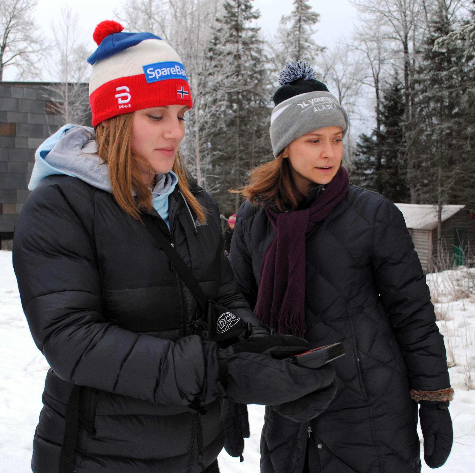 Kailey Mucha, left, and April Kaufman search for a beacon in the snow outside of the Kenai Wildlife Refuge Visitor’s Center during an avalanche training class on Saturday, Jan. 5 in Soldotna, Alaska. Mucha said she was interested in the course after spending some time snowmachining. (Photo by Kat Sorensen/Peninsula Clarion)