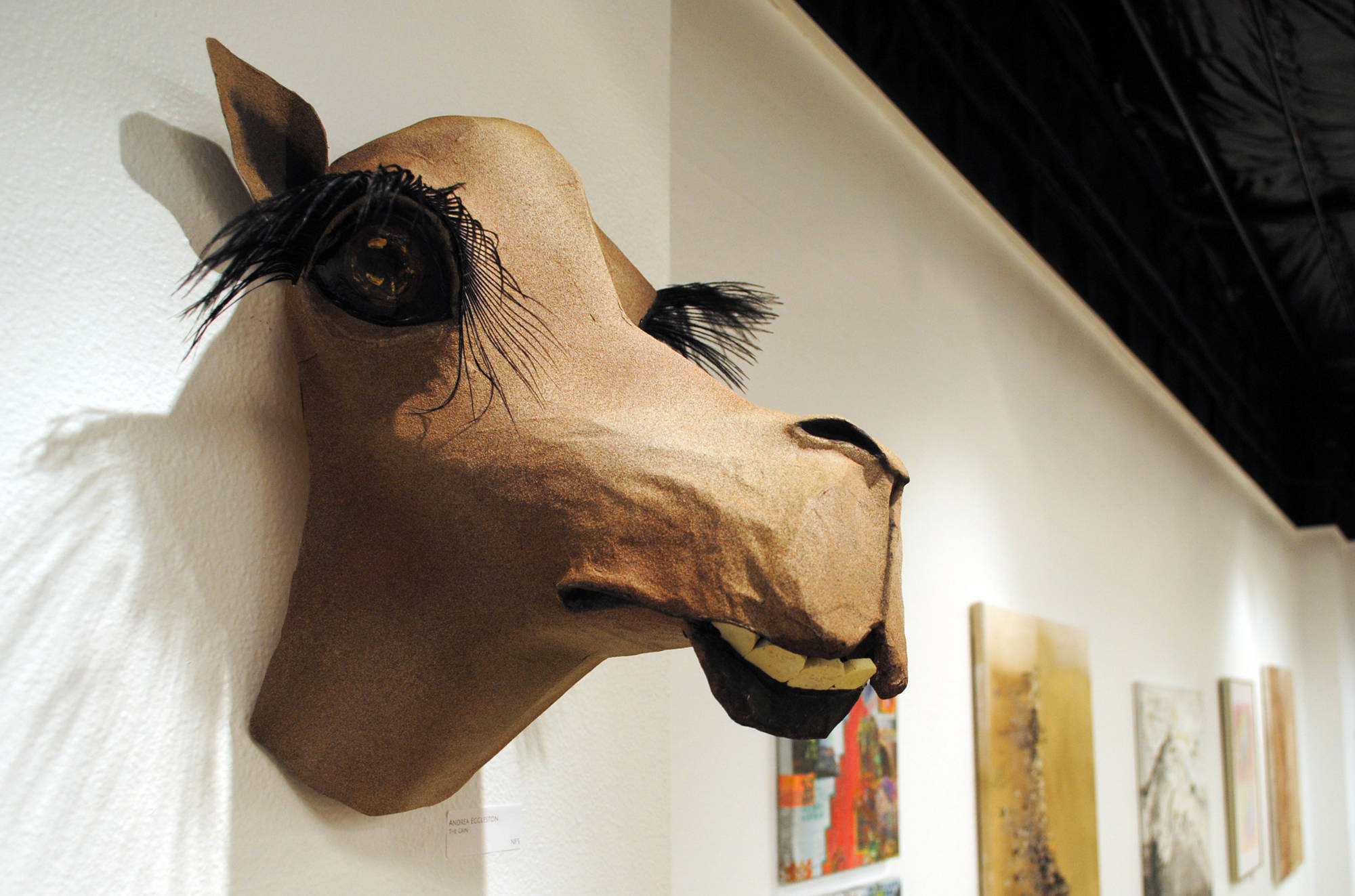 Kenai Peninsula Borough School District teacher Andrea Eggleston’s work ‘The Grin’ hangs at the Kenai Fine Arts Center in Kenai for the January exhibit which features art from teachers across the school district. (Photo by Kat Sorensen/Peninsula Clarion)