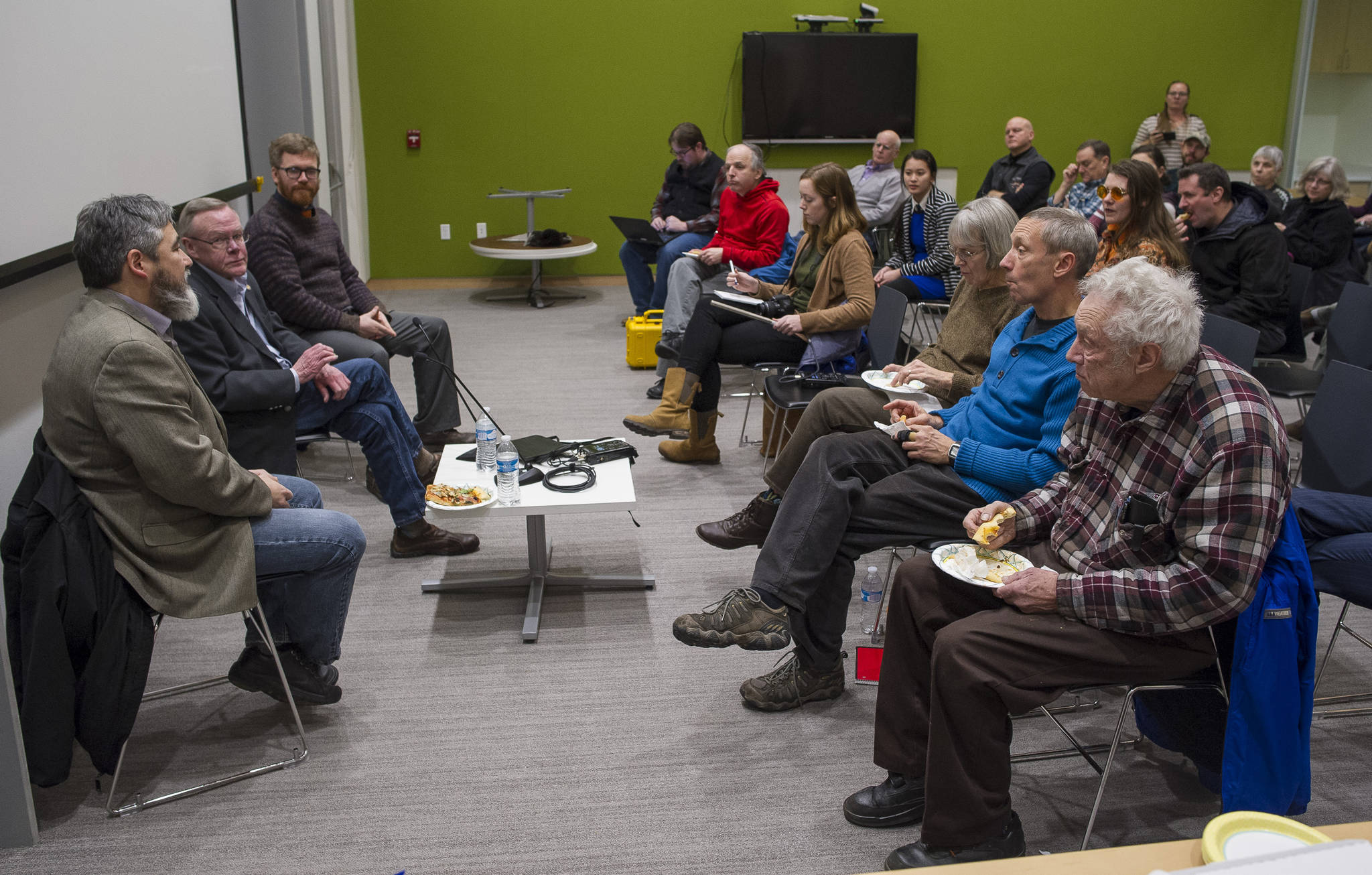 Rep. Sam Kito, D-Juneau, Sen. Dennis Egan, D-Juneau and Rep. Justin Parish, D-Juneau, answer questions from Juneau area residents about legislative priorities during a townhall meeting at the Mendenhall Valley Public Library on Thursday, Jan. 11, 2018. (Michael Penn | Juneau Empire)