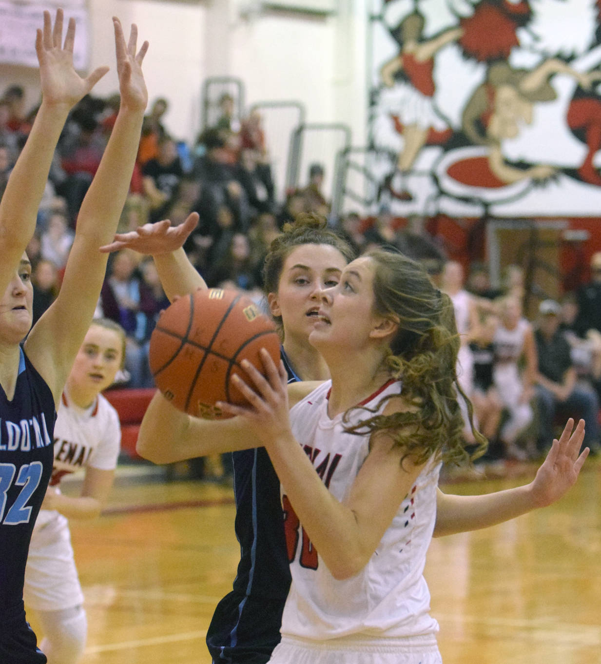 Soldotna’s Danica Schmidt and Aliann Schmidt try to stop Kenai Central’s Brooke Satathite on Tuesday, Jan. 16, 2018, on Cliff Massie Court at Kenai Central High School. (Photo by Jeff Helminiak/Peninsula Clarion)