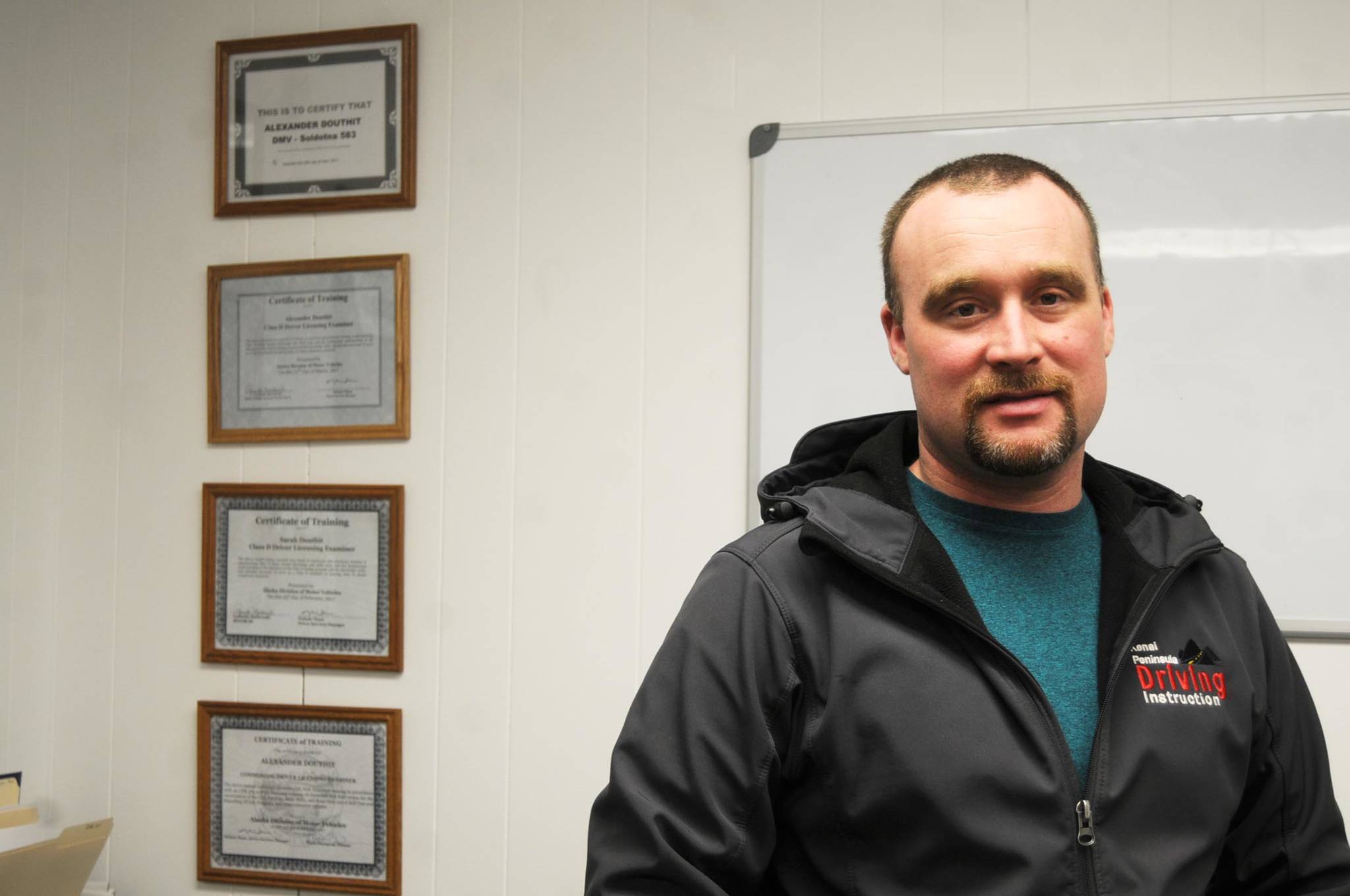 Alex Douthit, pictured in his office on Monday, Jan. 15, 2018 in Kenai, Alaska, founded Kenai Peninsula Driving Instruction in November 2016 with his wife Sarah Douthit. It took them more than a year to obtain all the permits and approvals they needed to officially begin commercial driver’s license instruction, which they are now focusing on. (Photo by Elizabeth Earl/Peninsula Clarion)