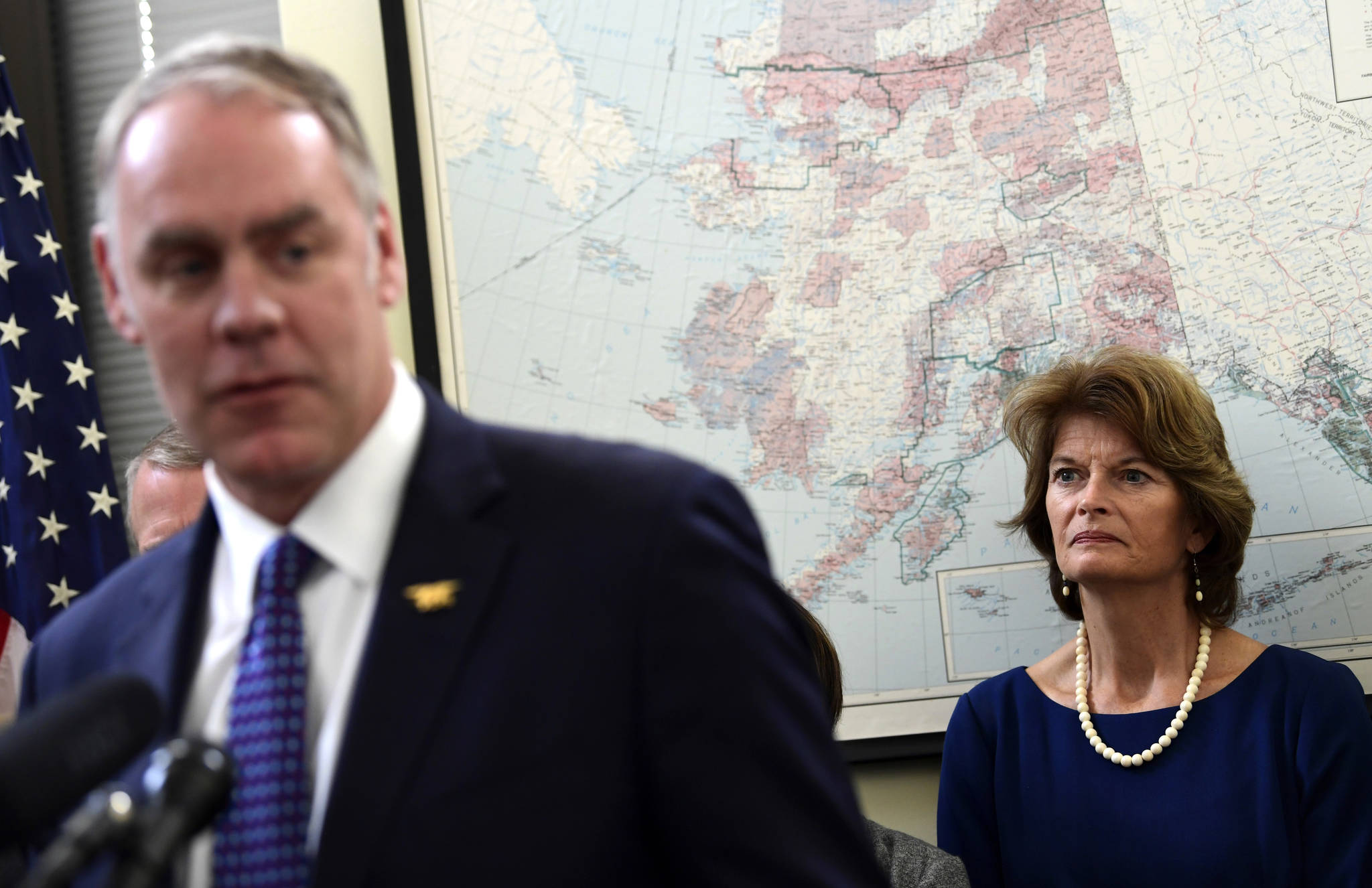 Sen. Lisa Murkowski, R-Alaska, right, listens as Interior Secretary Ryan Zinke, right, speaks during an event in her office on Capitol Hill in Washington, Monday, Jan. 22, 2018. Murkowski was joined by other Alaskan officials regarding the Interior Department’s decision to the construction of a road through a national wildlife refuge in Alaska. The road would connect the communities of King Cove and Cold Bay, which has an all-weather airport needed for emergency medical flights. (AP Photo/Susan Walsh)