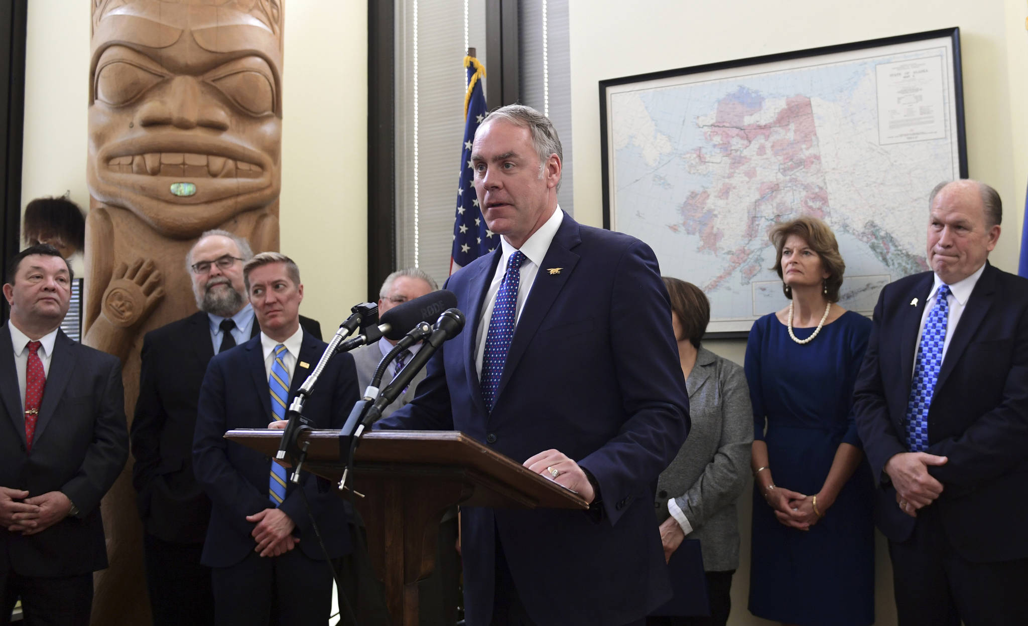 Interior Secretary Ryan Zinke, center, speaks during an event in the office of Sen. Lisa Murkowski, R-Alaska, second from right, on Capitol Hill in Washington, Monday, Jan. 22, 2018. Zinke was joined by Alaskan officials regarding the Interior Department’s decision to the construction of a road through a national wildlife refuge in Alaska.The road would connect the communities of King Cove and Cold Bay, which has an all-weather airport needed for emergency medical flights. Alaska Gov. Bill Walker listens at right. (AP Photo/Susan Walsh)