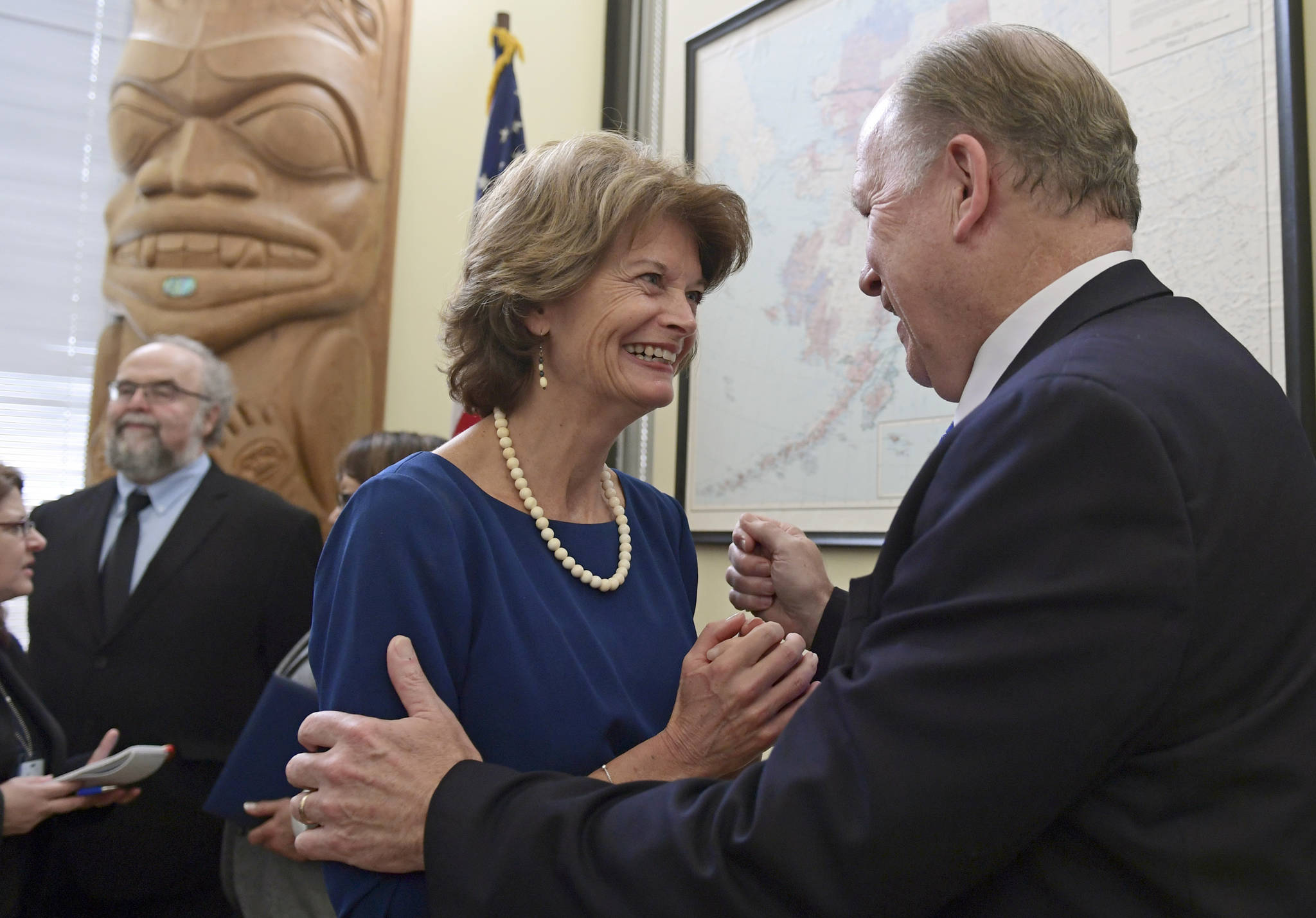 Sen. Lisa Murkowski, R-Alaska, center, talks with Alaska Gov. Bill Walker, right, following an event in her office on Capitol Hill in Washington, Monday, Jan. 22, 2018. Murkowski was joined by other Alaskan officials regarding the Interior Department’s decision to the construction of a road through a national wildlife refuge in Alaska.The road would connect the communities of King Cove and Cold Bay, which has an all-weather airport needed for emergency medical flights. (AP Photo/Susan Walsh)