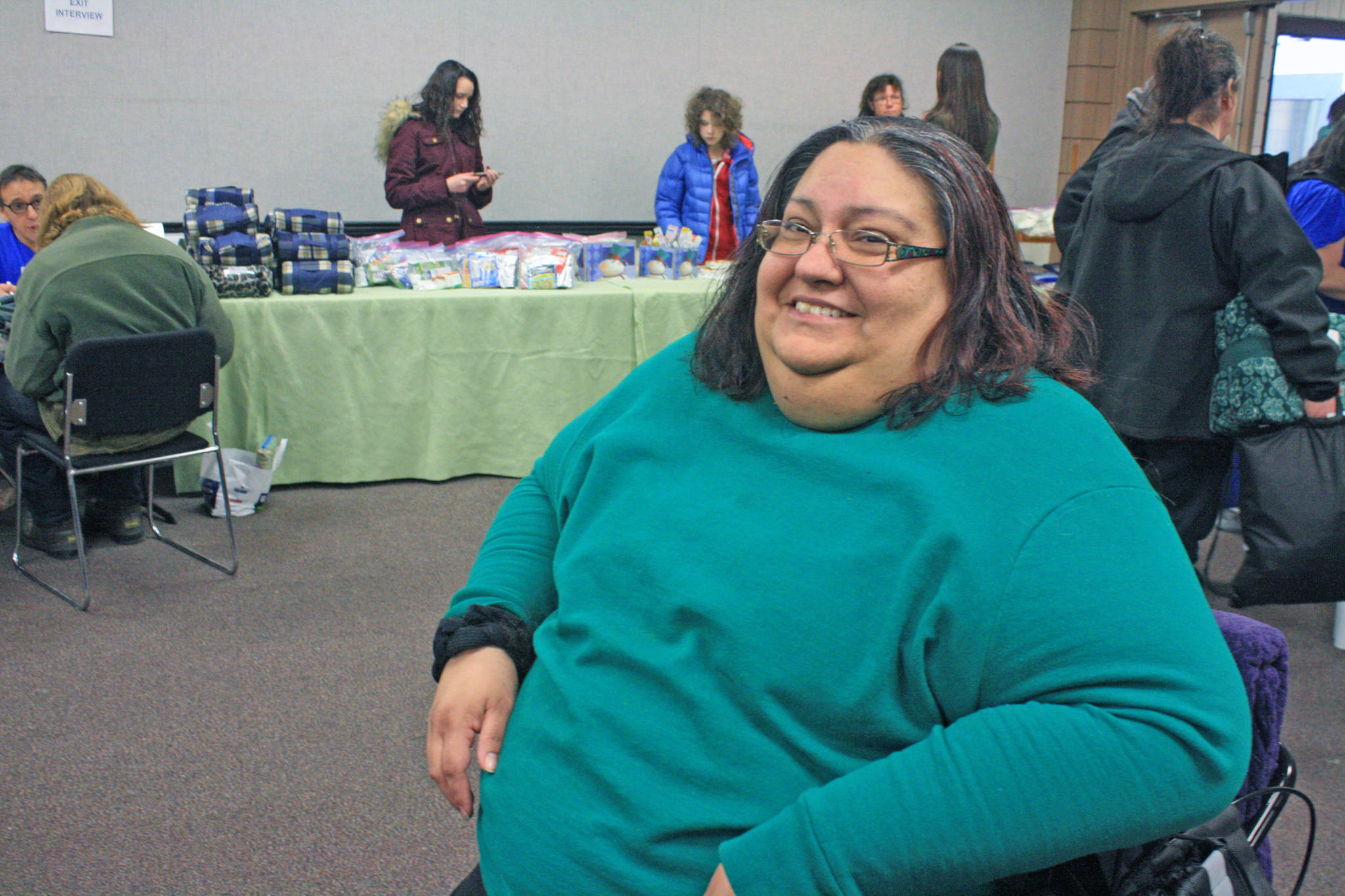 Krissanna French shows off her new haircut. French and her family attended the Jan. 24 Project Homeless to seek housing housing help. (Photo by Erin Thompson/Peninsula Clarion)