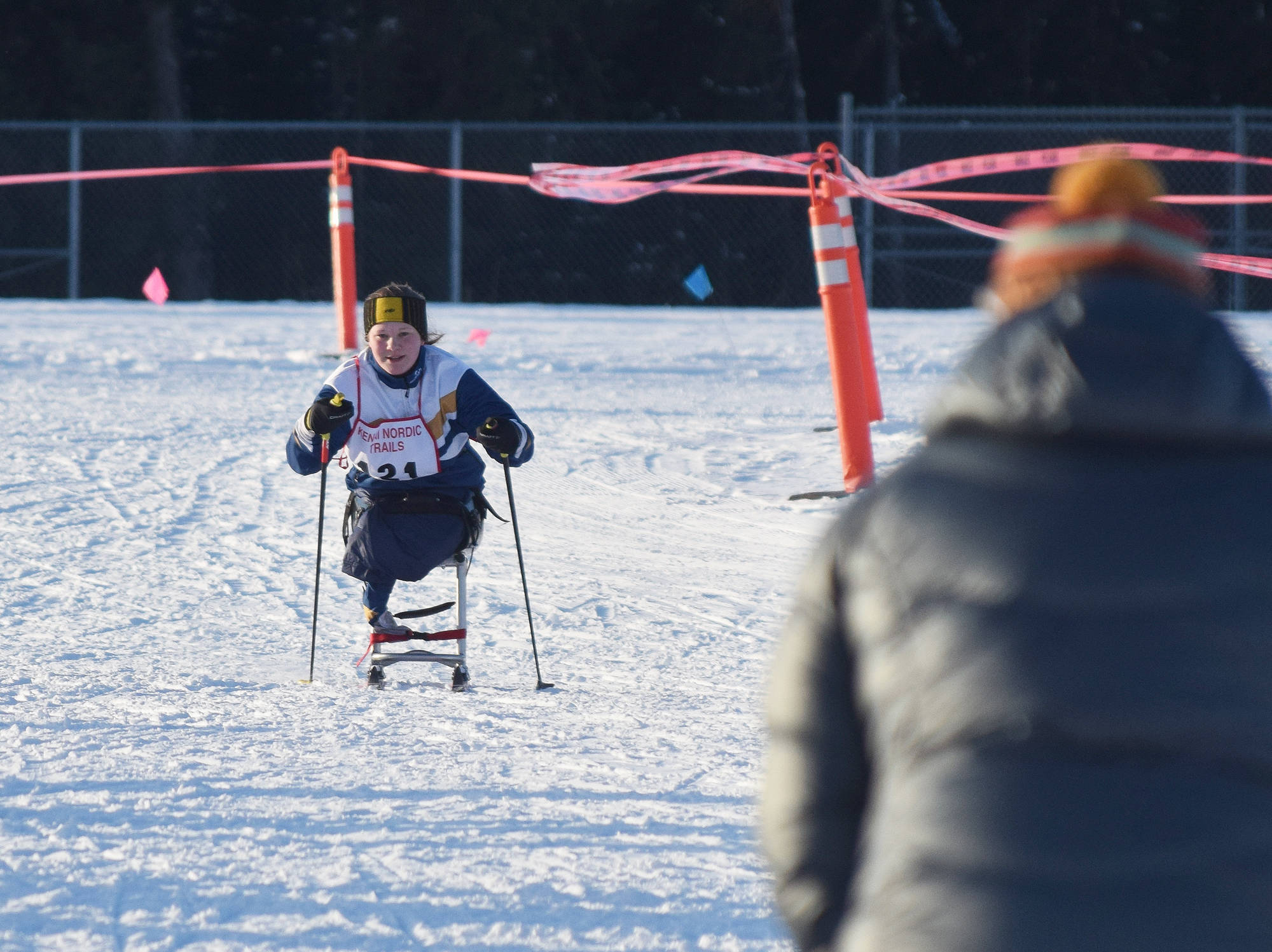 Angelica Haakenson of Homer approaches the finish line to cheers Friday afternoon in the Kenai Klassic races at the Tsalteshi Trails in Soldotna. (Photo by Joey Klecka/Peninsula Clarion)