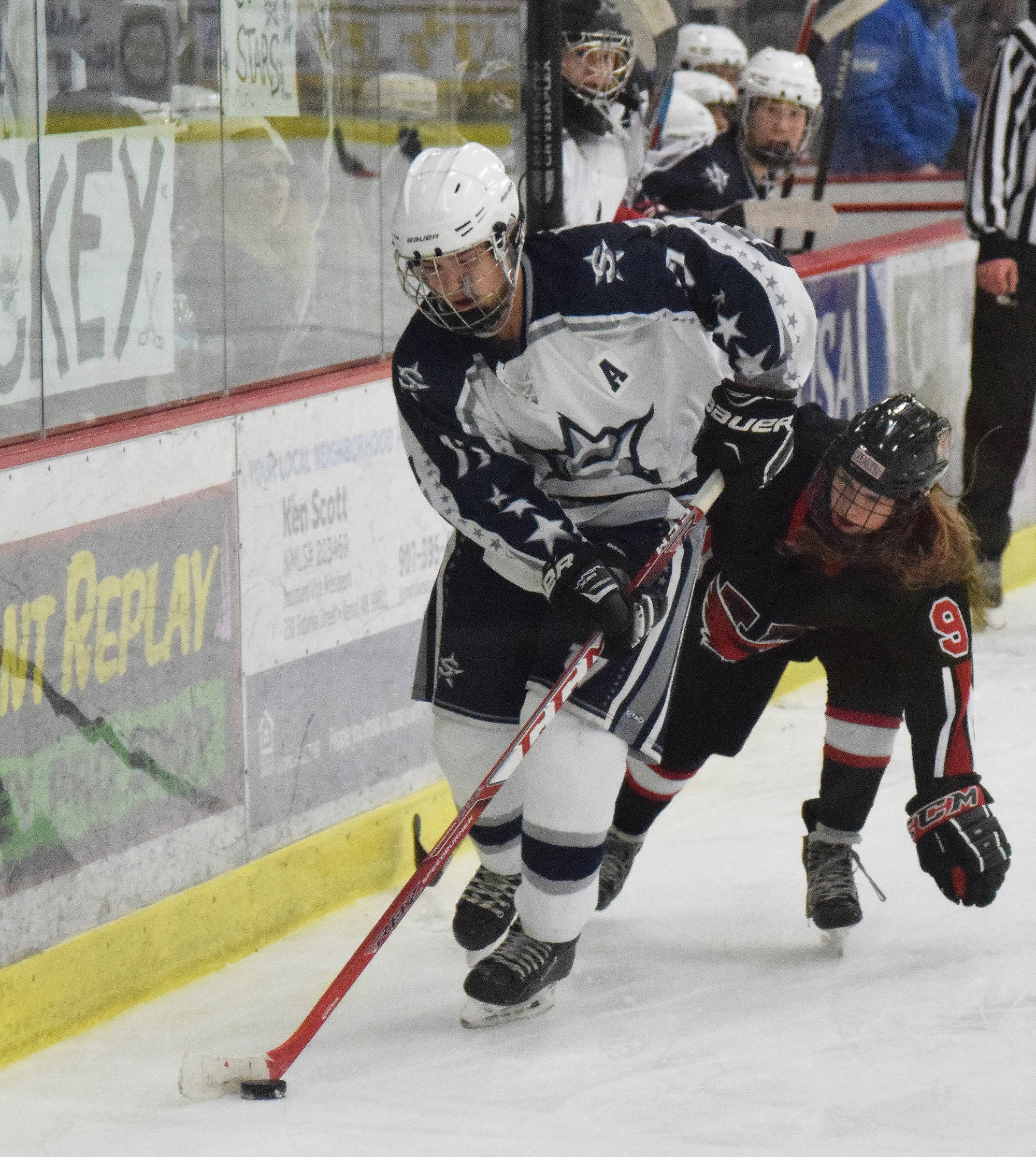 Soldotna’s Wyatt Medcoff evades Kenai’s Jordan Stock (right) Saturday night at the Soldotna Regional Sports Complex. (Photo by Joey Klecka/Peninsula Clarion)