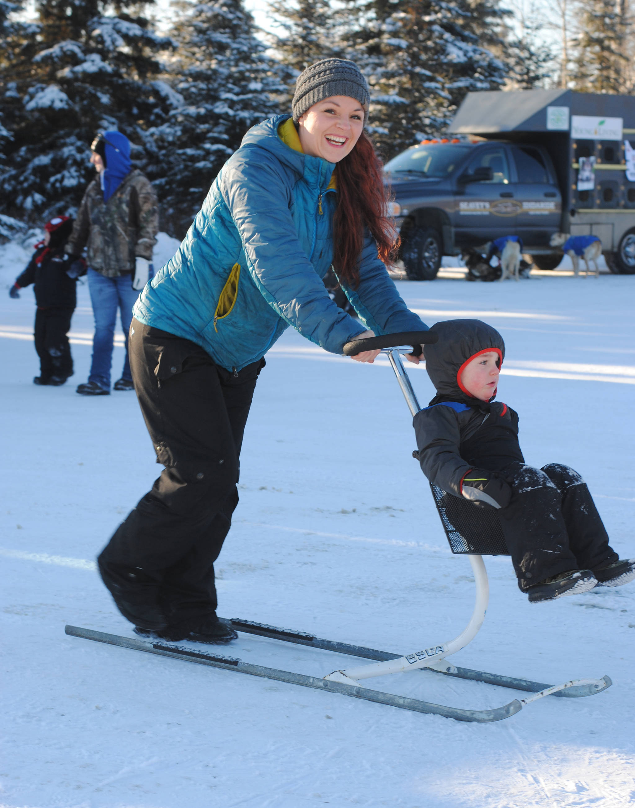 Donna Edmunds, of Soldotna, pushes her son Lucas on a ski buggy during the annual Peninsula Winter Games, which returned to Soldotna for the forty second year on Saturday at the Soldotna Regional Sports Complex. The event offered an array of children’s events and activities, including a Monopoly tournament, an outdoor film, free lunch and a carnival. The Kenai Peninsula Hockey Association also held an invitational hockey tournament during the event. (Photo by Kat Sorensen/Peninsula Clarion)