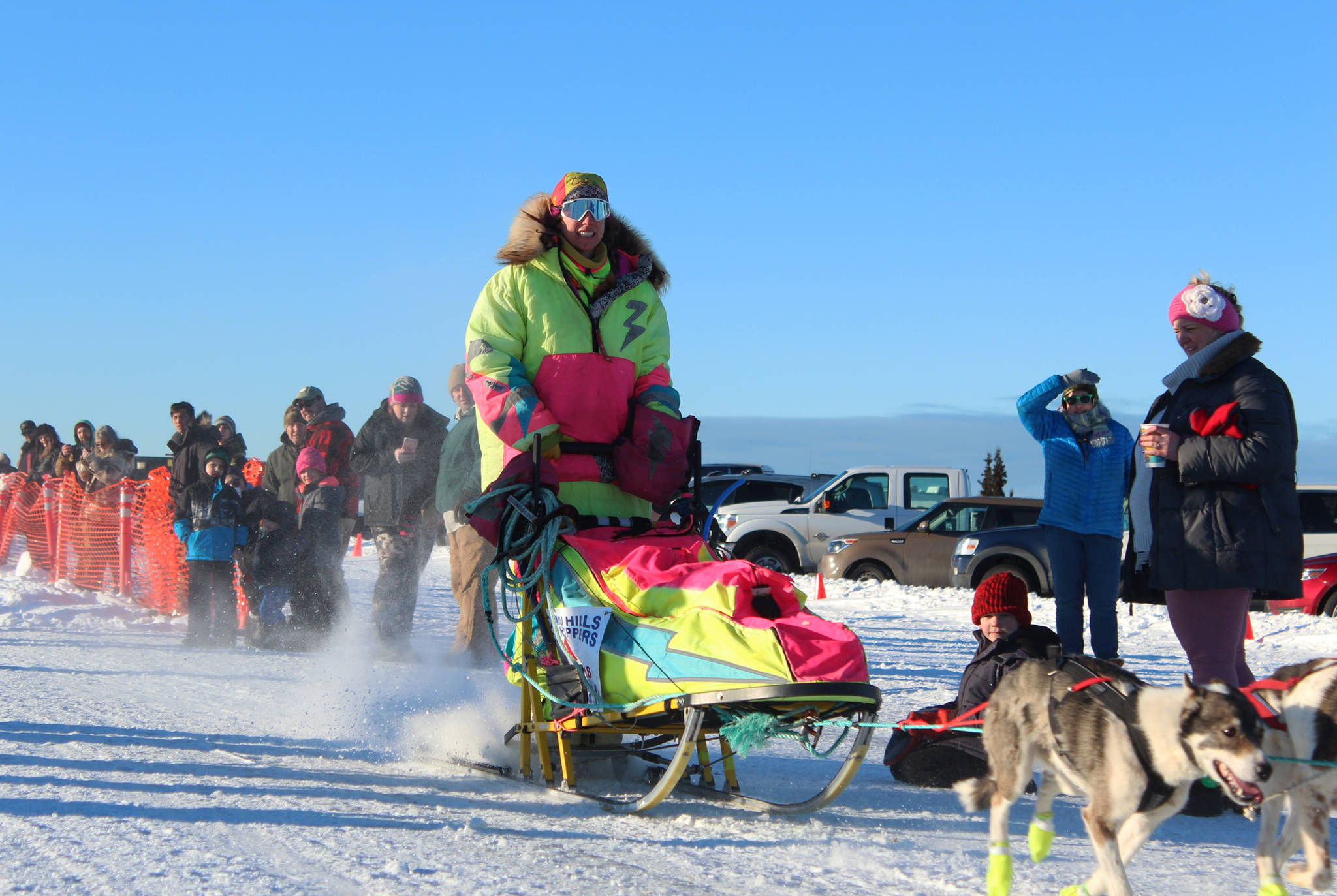 Monica Zappa, in her telltale neon garb, takes off with her team from the starting line of this year’s Tustumena 200 Sled Dog Race on Saturday, Jan. 27, 2018 at Freddie’s Roadhouse in Ninilchik, Alaska. (Photo by Megan Pacer/Homer News)