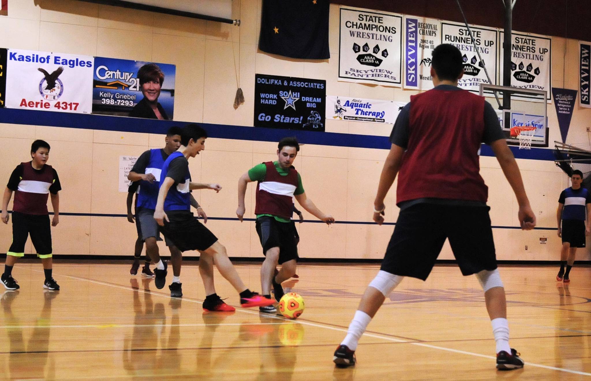 Soccer players vie for the ball during a game of futsal hosted by the Soldotna Community Schools program on Wednesday, Jan. 31, 2018 in Soldotna, Alaska. Futsal, a type of soccer, is a South American tradition in which players compete on a hard court rather than on turf for short games with five people on each team. Joel Todd, who coordinates the Community Schools program for the city of Soldotna, said the games on Wednesdays attract people of both genders and a variety of ages. Kids play from 6&