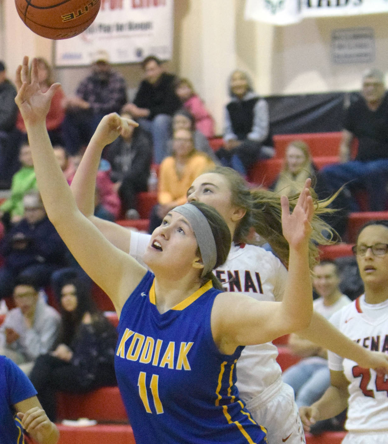 Kodiak’s Katrina Pruitt and Kenai Central’s Liz Hanson battle for the ball Friday, Feb. 2, 2018, at Kenai Central High School. (Photo by Jeff Helminak/Peninsula Clarion)