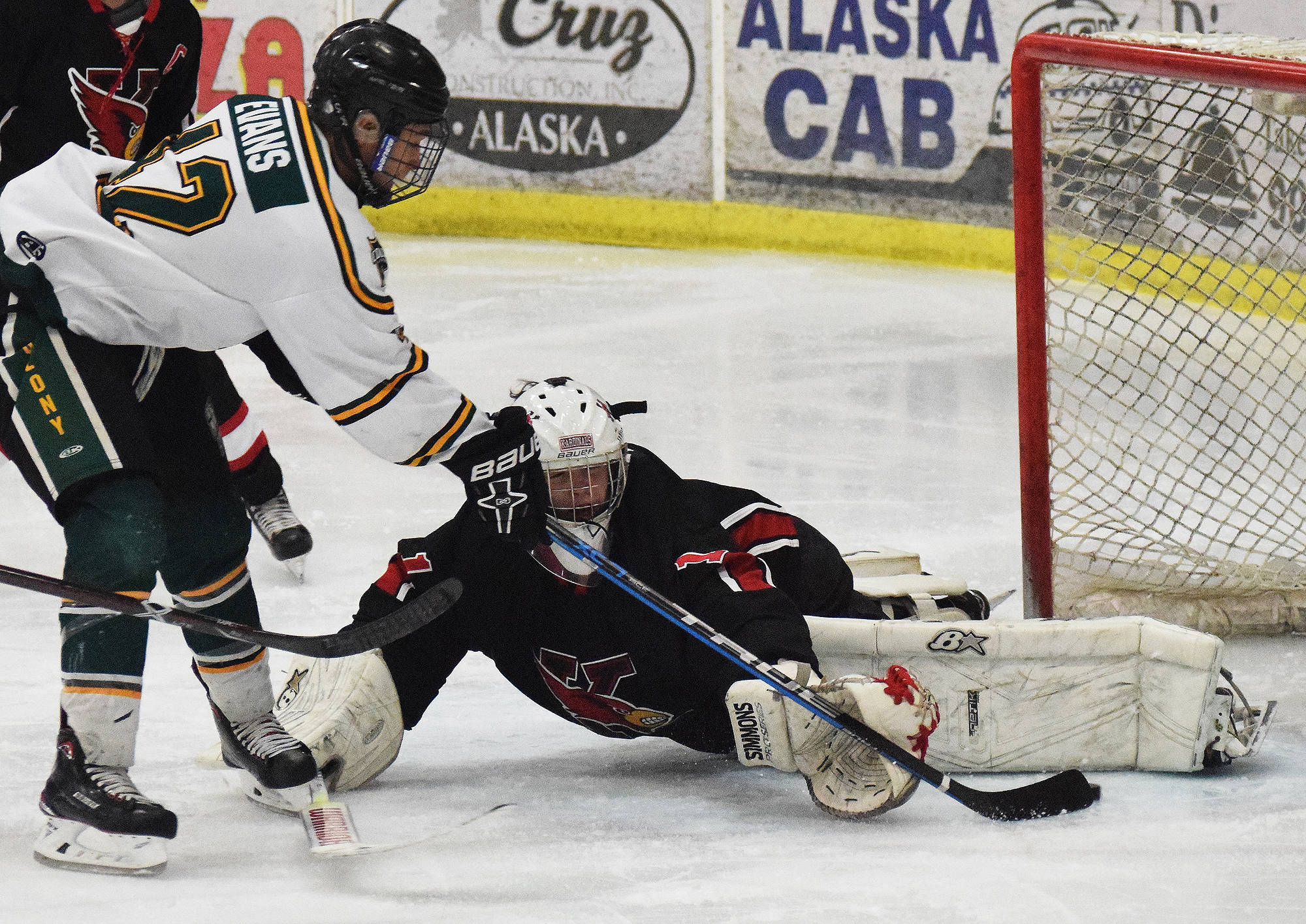 Kenai Central goalie Josh Tree blocks a shot from Colony’s Tae’jean Evans Friday in a North Star Conference tournament semifinal at the Soldotna Regional Sports Complex. (Photo by Joey Klecka/Peninsula Clarion)