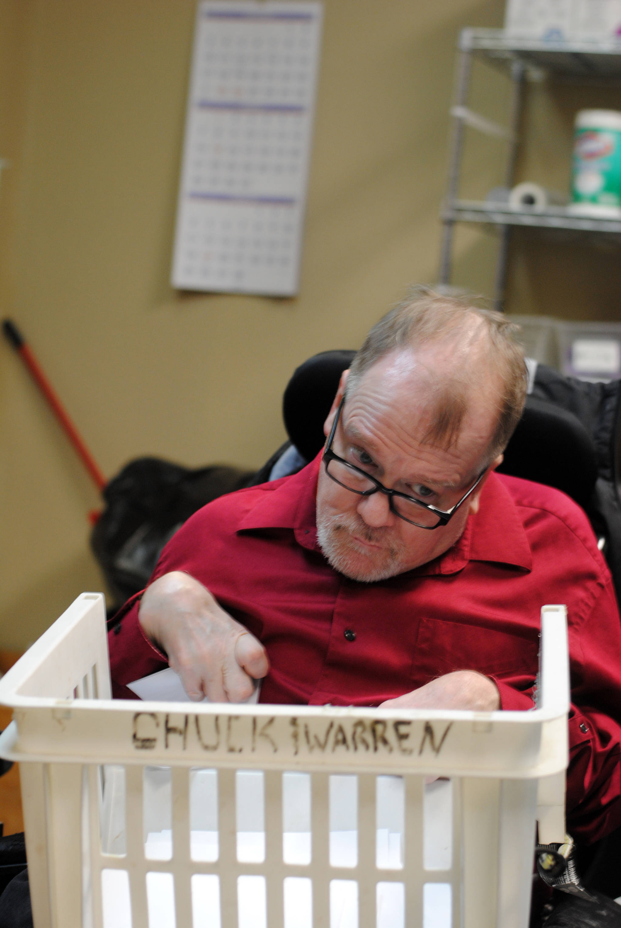 Chuck Davis shreds paper at the Frontier Community Services office in Soldotna on Jan. 18, 2018, his last day of work after 33 years with the non-profit agency. (Photo by Kat Sorensen/Peninsula Clarion)