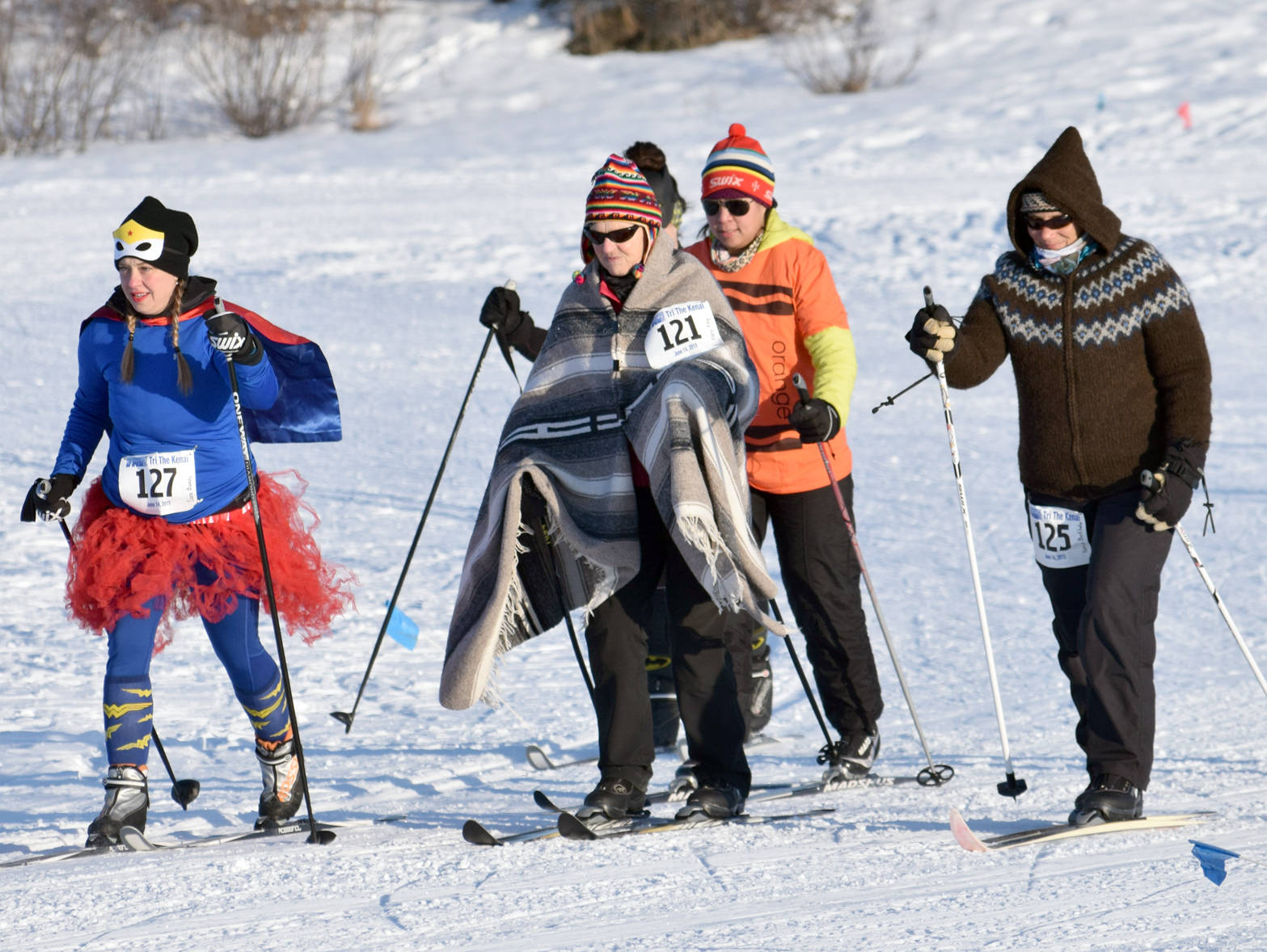 Sara Bundy (127), Mary King (121) and Patricia Berkhahn (125) lead a group of skiers Sunday, Feb. 4, 2018, at the Ski For Women at Tsalteshi Trails. (Photo by Jeff Helminiak/Peninsula Clarion)