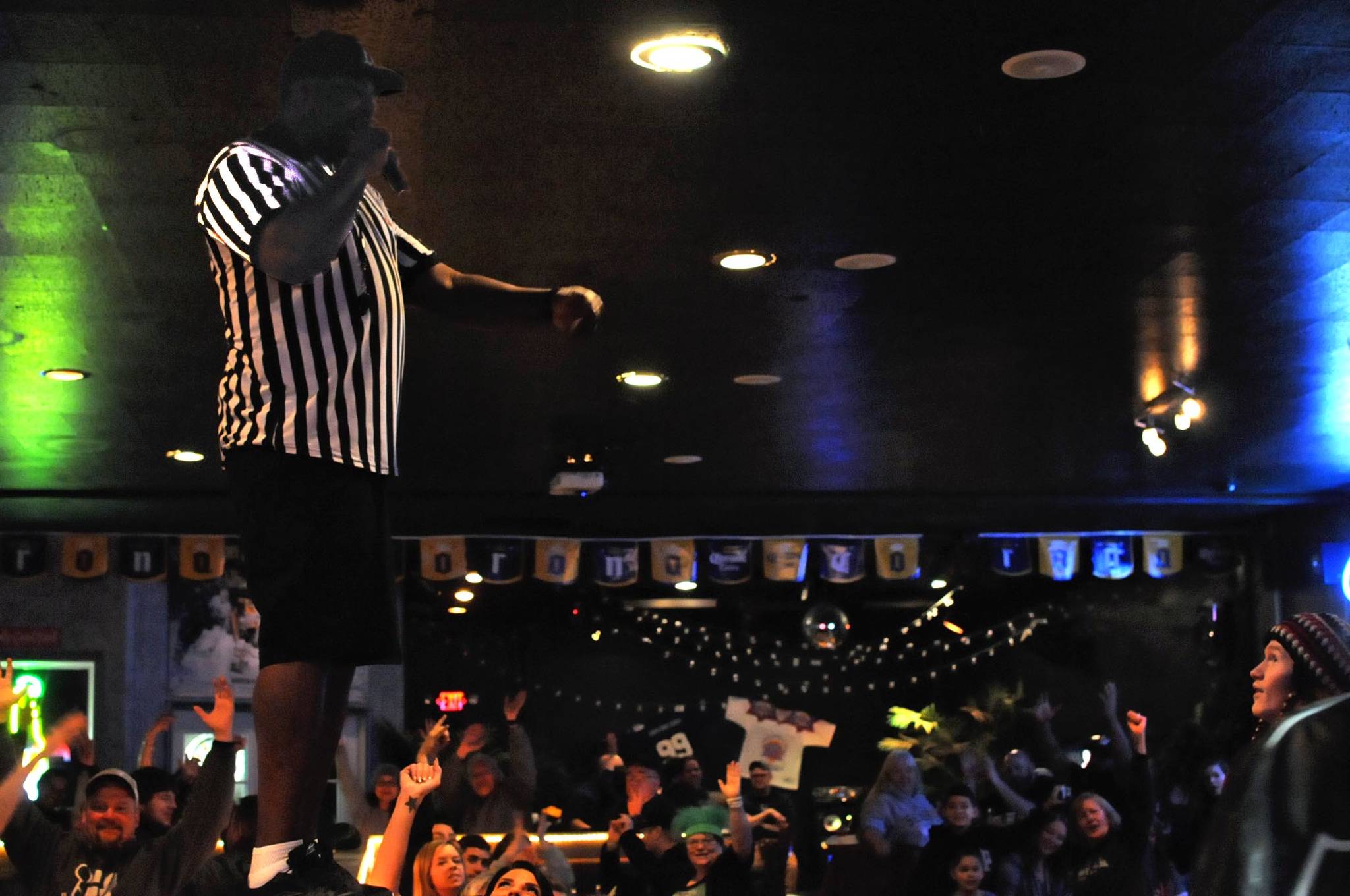 Harris “Biz” Richardson, a bartender at the Main Street Tap and Grill, draws a cheer from the crowd gathered at the restaurant for the Superbowl on Sunday, Feb. 4, 2018 in Kenai, Alaska. The New England Patriots and the Philadelphia Eagles battled it out in Minnesota for the Superbowl LII title Sunday, with the Eagles triumphing 41-33. Football fans packed bars like the Main Street and the Back Door Lounge in Kenai on Sunday to watch the game, and the bars hosted parties and giveaways in response. The Back Door drew tickets for T-shirts and the Main Street hosted a Super Bowl Party sponsored by Corona with a giveaway with a theater recliner as the grand prize. (Photo by Elizabeth Earl/Peninsula Clarion)
