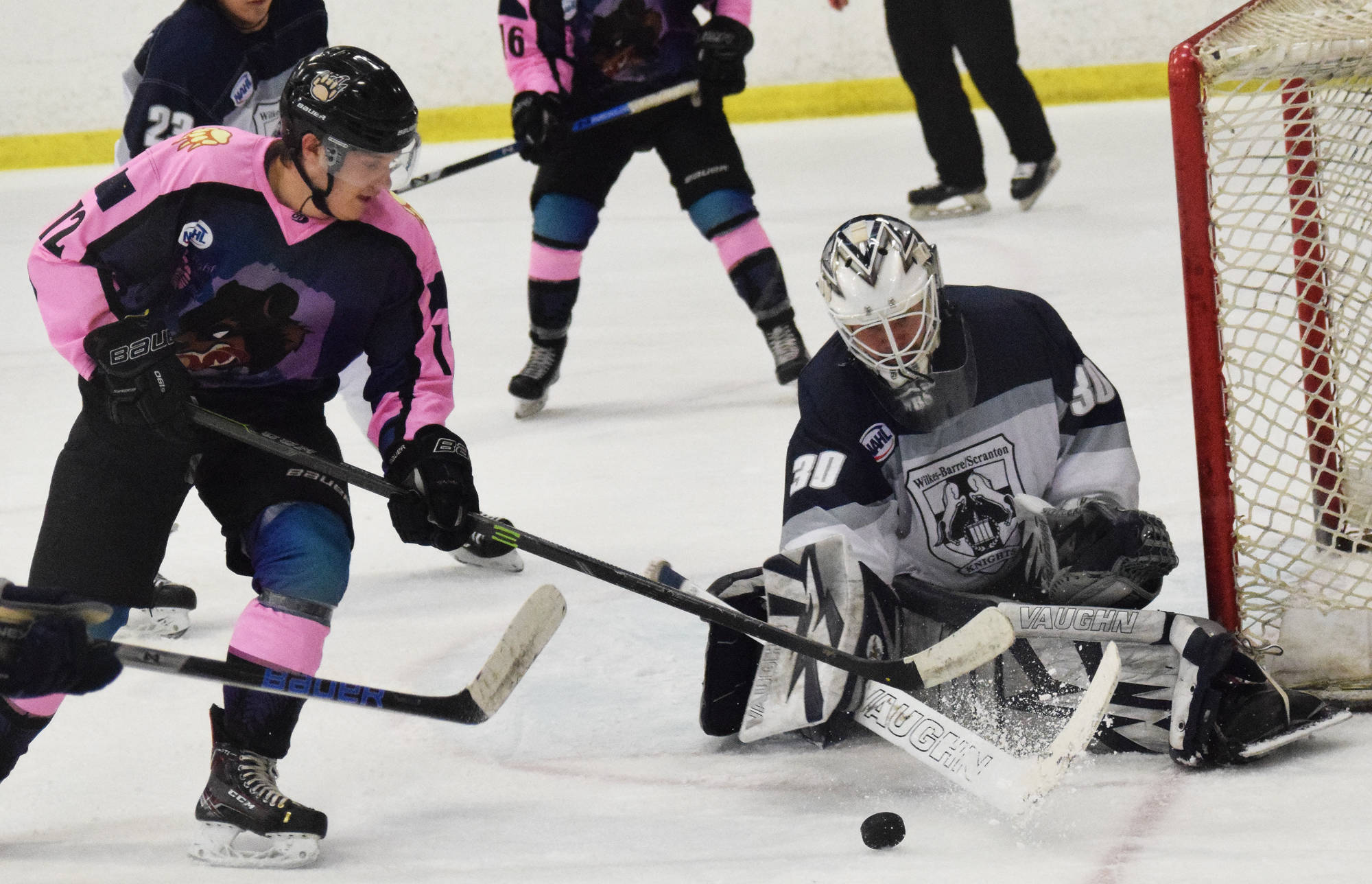 Filip Karlsson of the Kenai River Brown Bears (left) looks for a shot against Wilkes-Barre/Scranton Knights goaltender David Tomeo Friday night at the Soldotna Regional Sports Complex. (Photo by Joey Klecka/Peninsula Clarion)