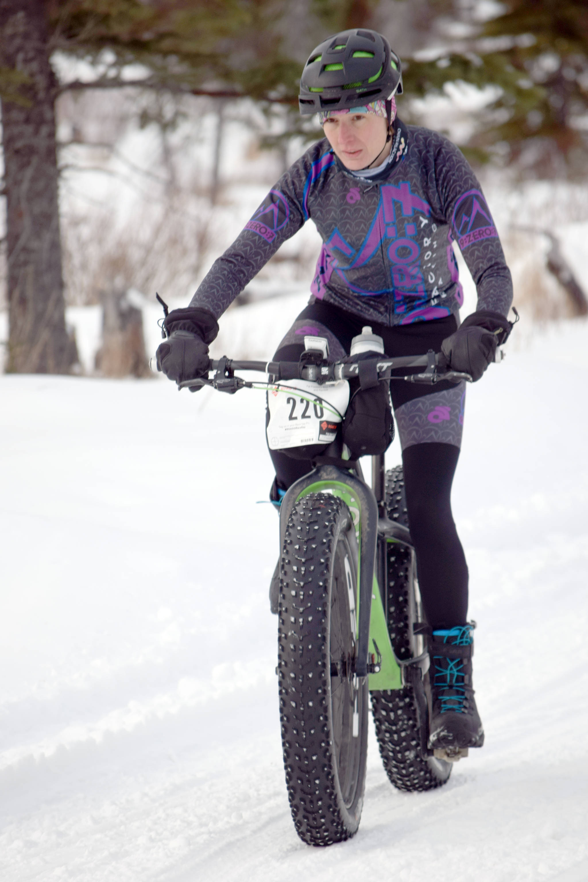 Women’s winner Amber Bethe glides down the bottom of a hill during the second half of Fat Freddie’s Bike Race and Ramble on Saturday, Feb. 10, 2018, in the Caribou Hills. (Photo by Jeff Helminiak/Peninsula Clarion)