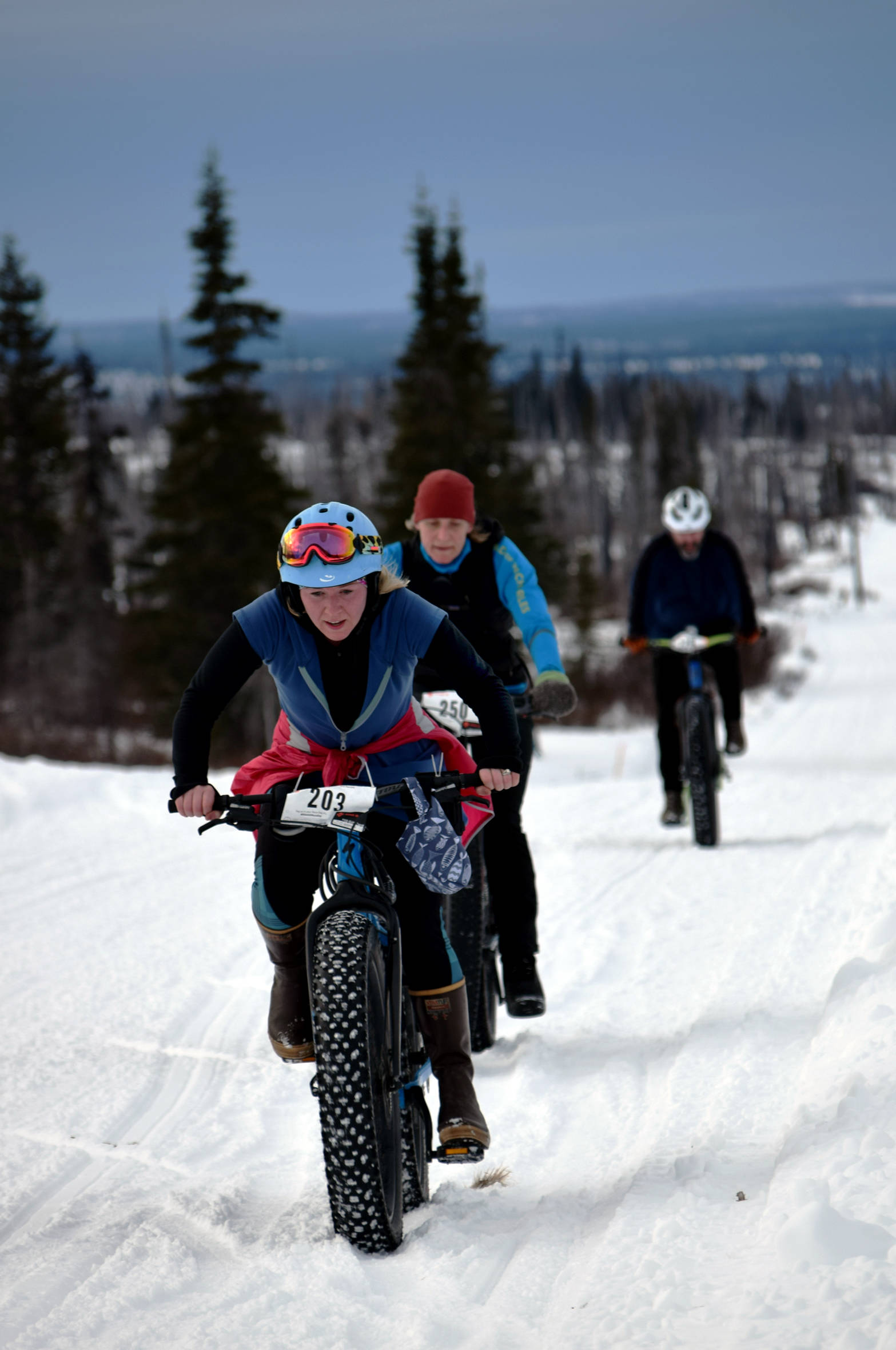 Sara Barrowcliff leads Heidi Isernhagen and Trevor Davis up a hill in the first half of Fat Freddie’s Bike Race and Ramble on Saturday, Feb. 10, 2018, in the Caribou Hills. (Photo by Jeff Helminiak/Peninsula Clarion)