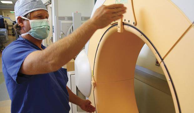 In this July 2011 file photo, Kenai Spine orthopedic spine surgeon Dr. Craig Humphreys discusses how the O-arm machine takes 3-D images as a surgery aid at Central Peninsula Hospital in Soldotna, Alaska. (Clarion file photo)