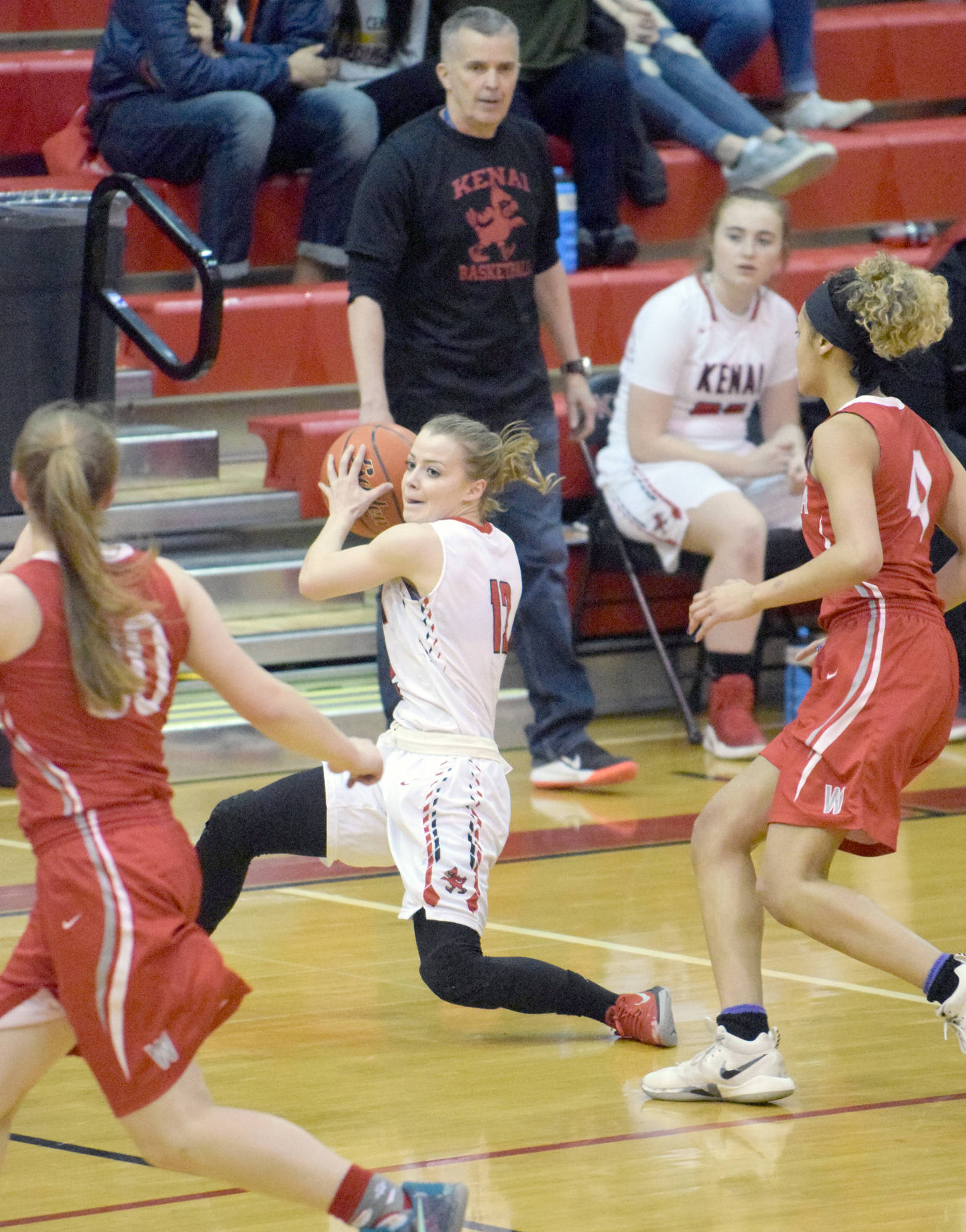 Kenai Central’s Hayley Maw works against the Wasilla press Wednesday, Feb. 14, 2018, on Cliff Massie at Kenai Central High School. (Photo by Jeff Helminiak/Peninsula Clarion)