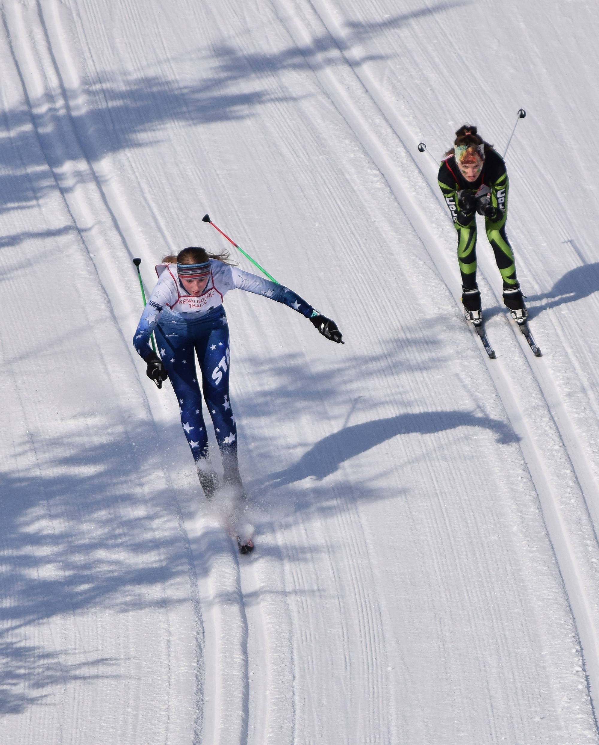 Cameron Blackwell of Soldotna (left) loses control on a late downhill Saturday afternoon in the girls race at the Region III skiing championships at the Tsalteshi Trails in Soldotna. (Photo by Joey Klecka/Peninsula Clarion)