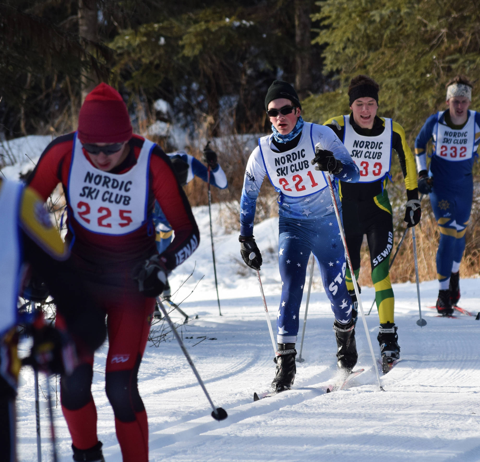 Joseph Dammeyer (221) of Soldotna keeps pace with Josh Foster of Kenai (225) and Seward’s Egor Sturdy (233) in the boys race Saturday afternoon at the Region III skiing championships at the Tsalteshi Trails in Soldotna. (Photo by Joey Klecka/Peninsula Clarion)