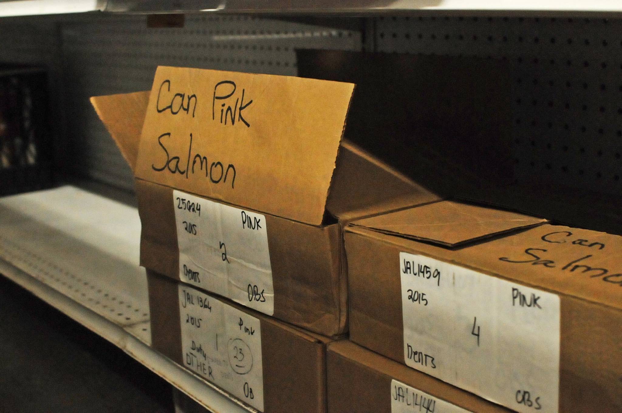 Boxes of canned pink salmon sit on the shelves at the Kenai Peninsula Food Bank waiting to be distributed on Thursday, Feb. 8, 2018 in Soldotna, Alaska. (Photo by Elizabeth Earl/Peninsula Clarion)