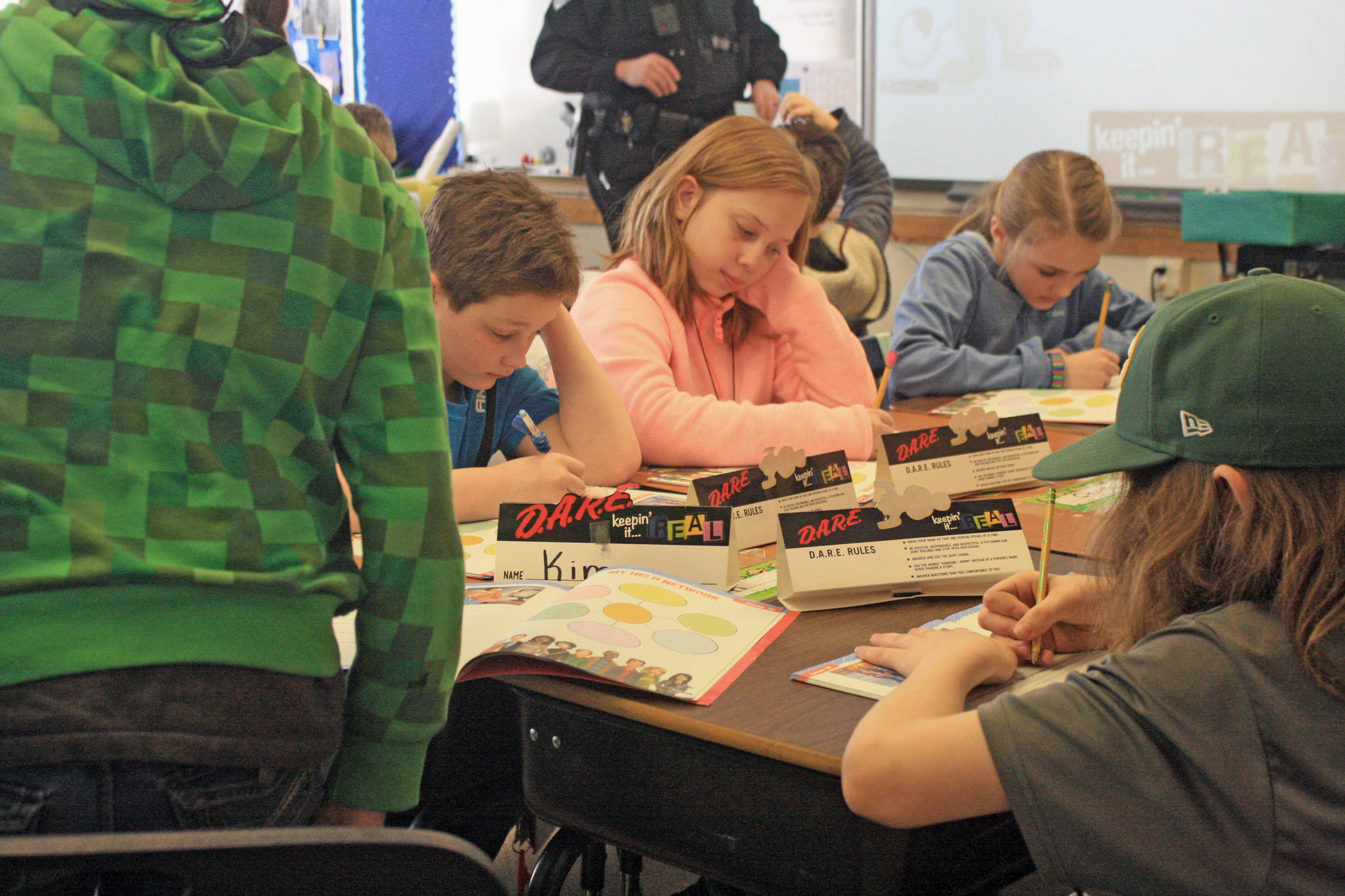 Fifth-graders fill out D.A.R.E. workbooks during a lesson at Soldotna Elementary School on Wednesday, Feb. 28. (Photo by Erin Thompson/Peninsula Clarion)