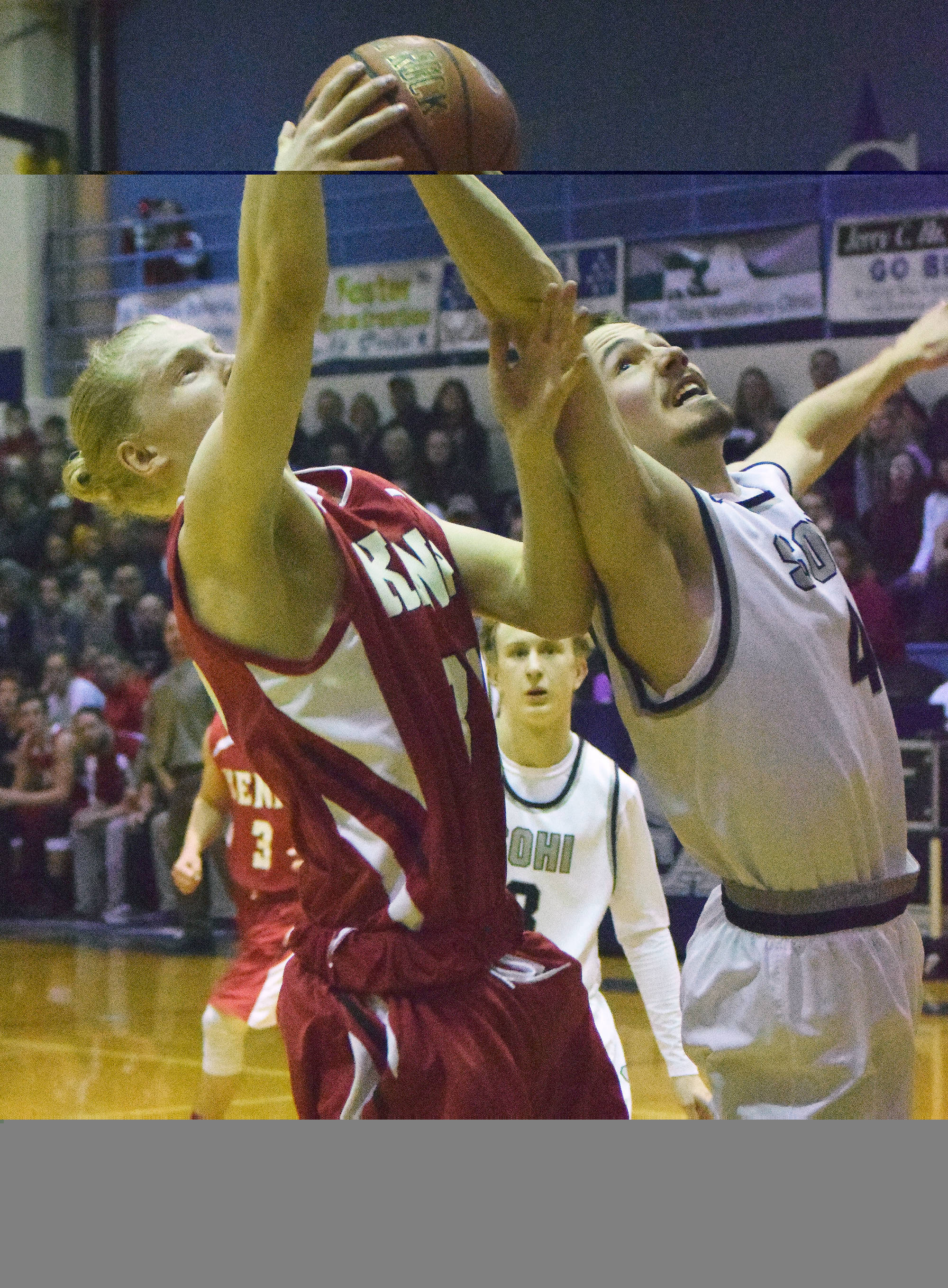 Preben Strende of Kenai Central (left) and Caleb Spence of Soldotna contest a rebound Saturday night at Soldotna High School. (Photo by Joey Klecka/Peninsula Clarion)