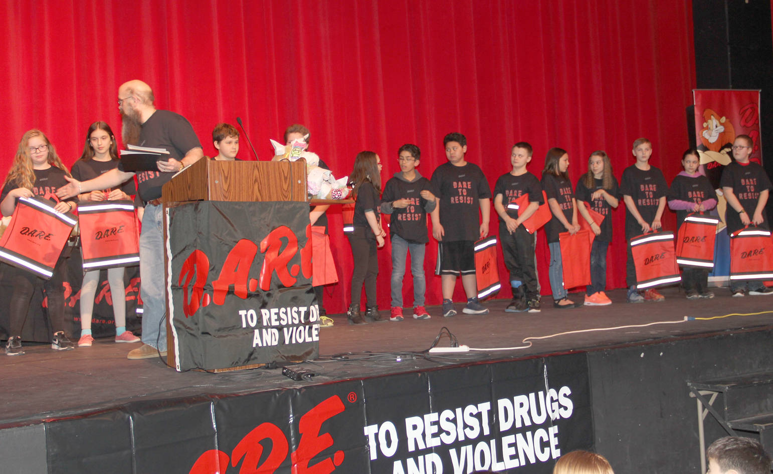 D.A.R.E. grads receive goodie bags and congratulations from community leaders.