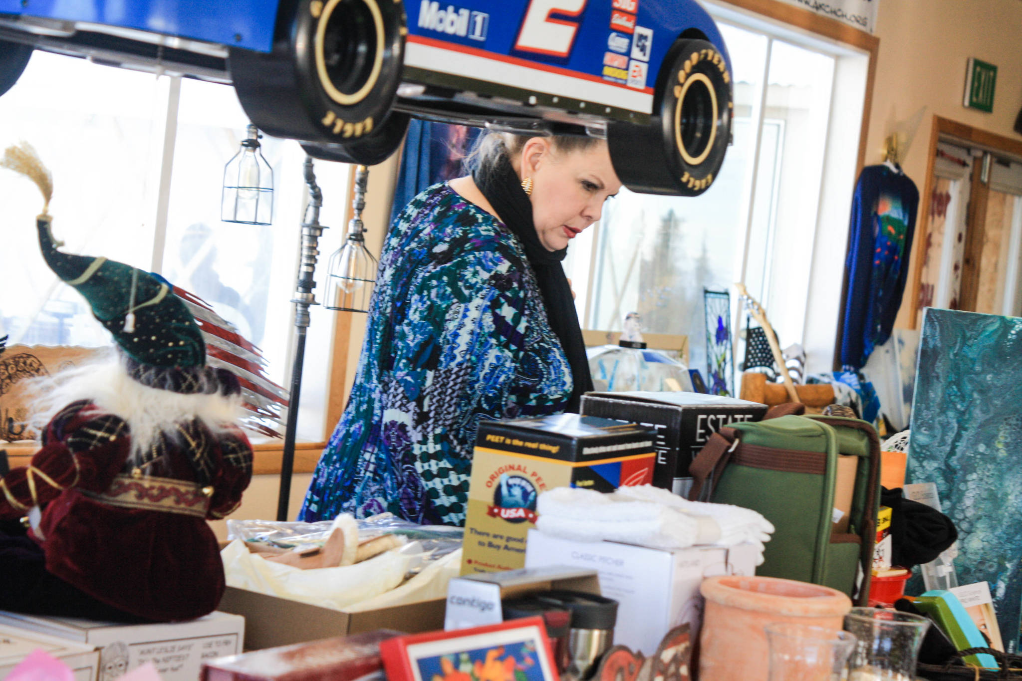 A woman checks out items offered for auction during the WOW fundraiser for cancer patients held on Saturday, Feb. 24, 2018 at Freddie’s Roadhouse in the Caribou Hills near Ninilchik, Alaska. (Photo by Erin Thompson/Peninsula Clarion)