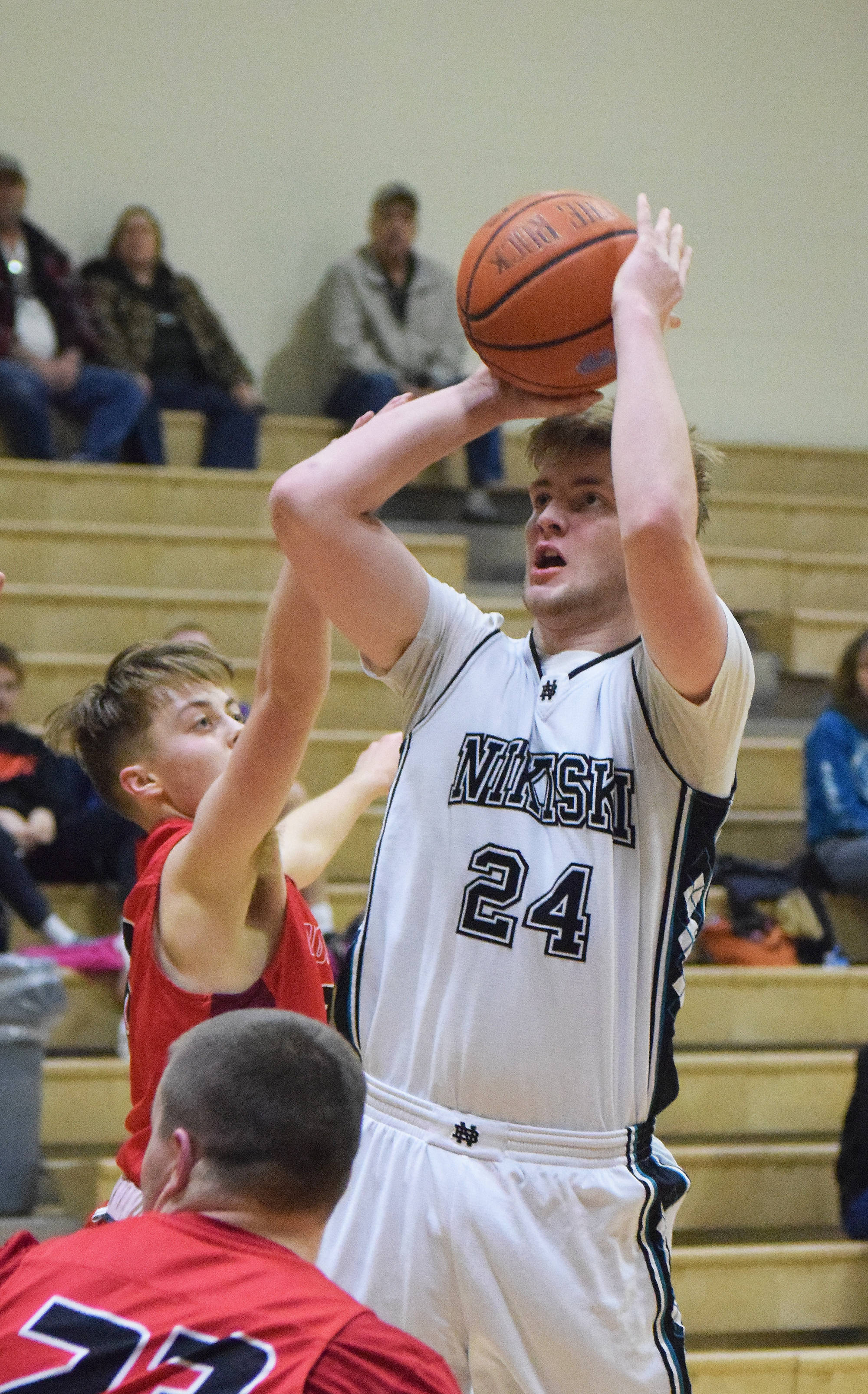 Nikiski’s Cody Handley takes a shot March 2, 2018, against Houston at Nikiski High School. (Photo by Joey Klecka/Peninsula Clarion)