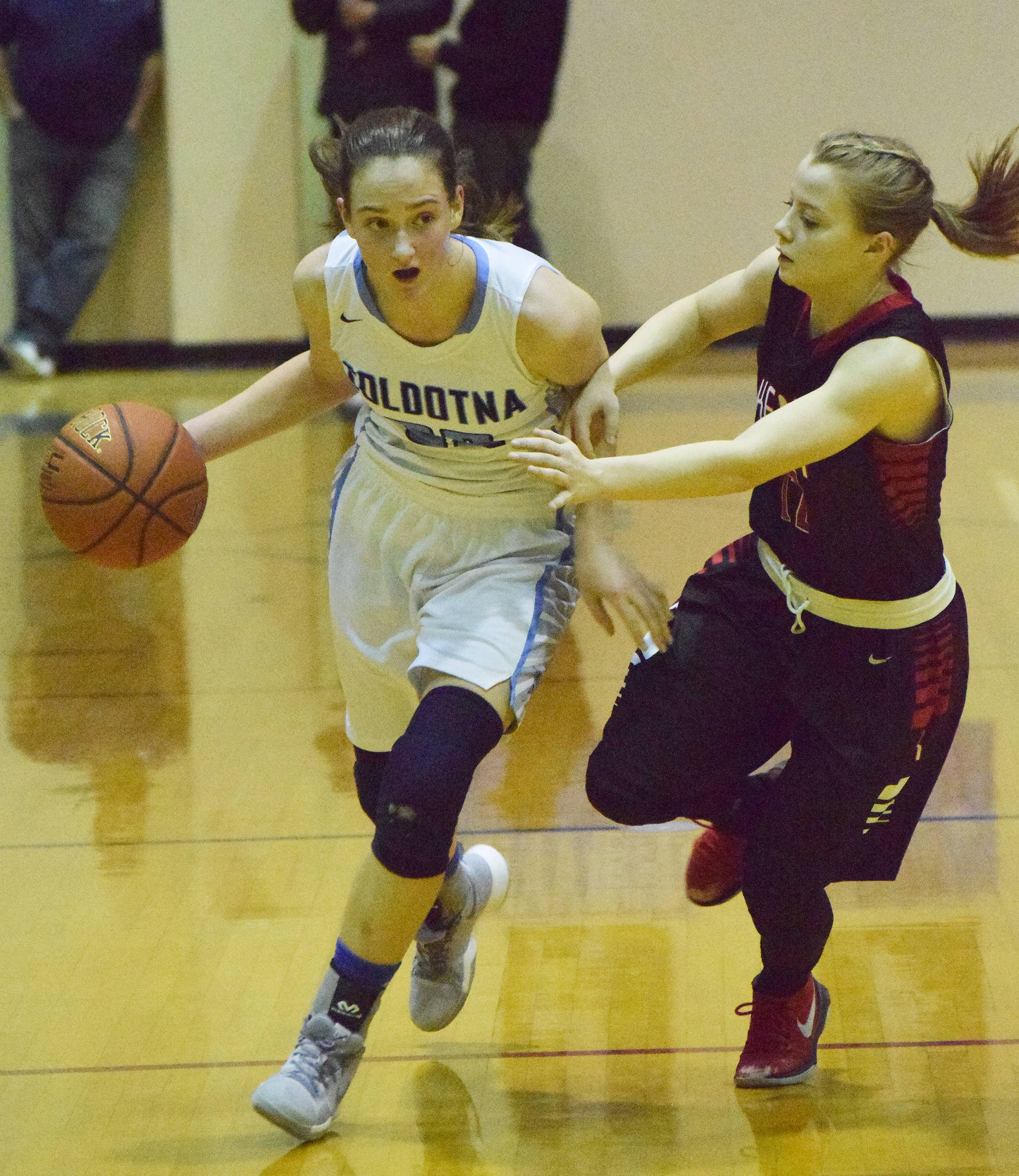 Soldotna’s Danica Schmidt (left) looks for an open teammate with Kenai’s Hayley Maw guarding her Saturday, March 3, 2018, night at Soldotna High School. (Photo by Joey Klecka/Peninsula Clarion)