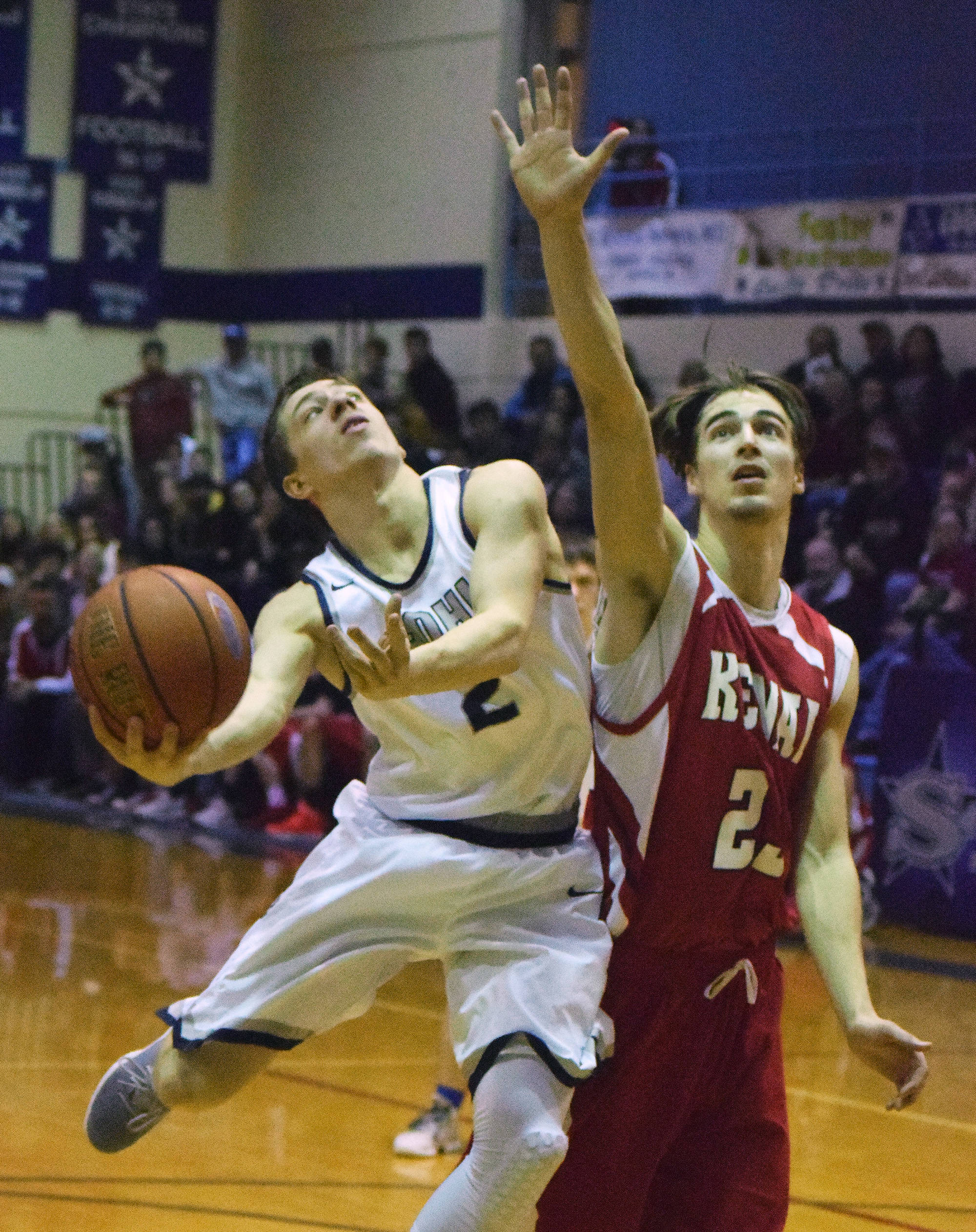 Soldotna’s Jersey Truesdell (right) puts up a shot against Kenai’s Luke Beiser Saturday, March 3, 2018, at Soldotna High School. (Photo by Joey Klecka/Peninsula Clarion)