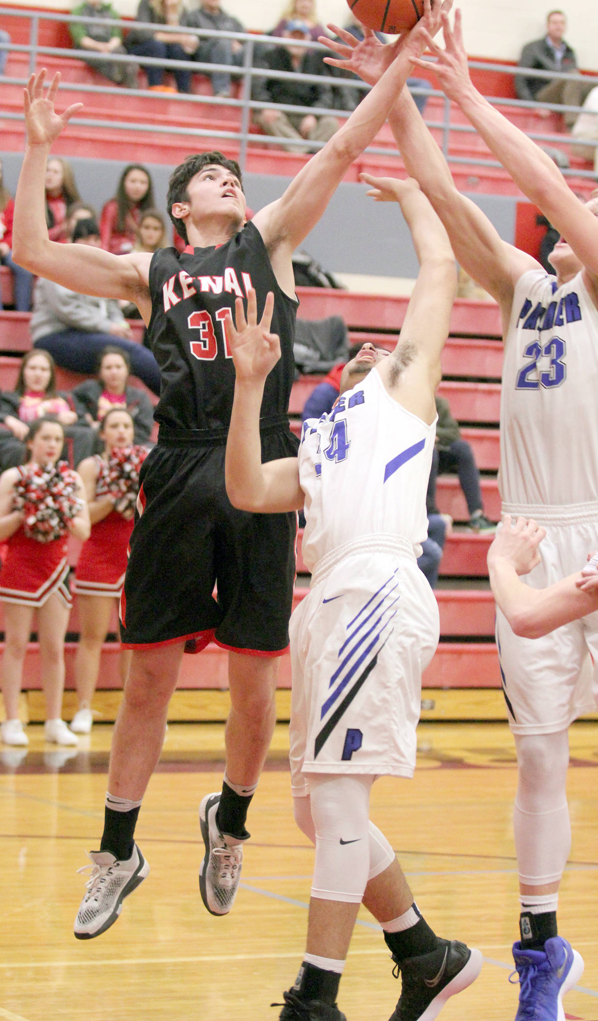 Kenai Central junior Adam Trujillo works to get a rebound against Palmer during the Northern Lights Conference Championships quarterfinals Thursday, March 8, 2018, at Wasilla High School. (Photo by Jeremiah Bartz/Frontiersman.com)