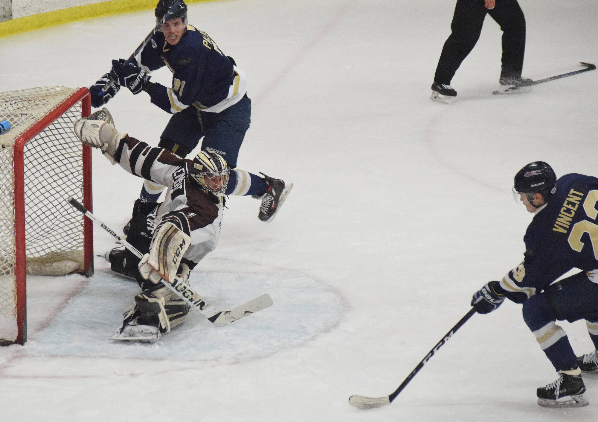 Kenai River goaltender Gavin Enright stretches for a save with Janesville (Wisconsin) skater Jack Vincent bearing down on him Friday night at the Soldotna Regional Sports Complex. (Photo by Joey Klecka/Peninsula Clarion)