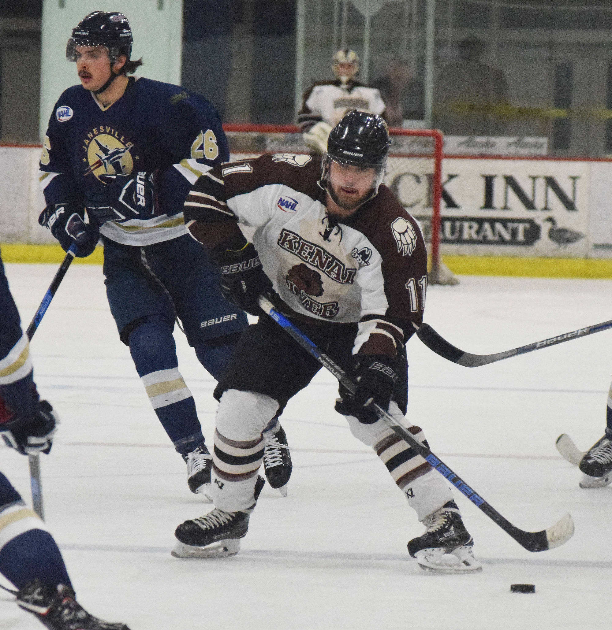 Kenai River forward Emils Ezitis checks for holes in the Janesville (Wisconsin) defense Friday night at the Soldotna Regional Sports Complex. (Photo by Joey Klecka/Peninsula Clarion)