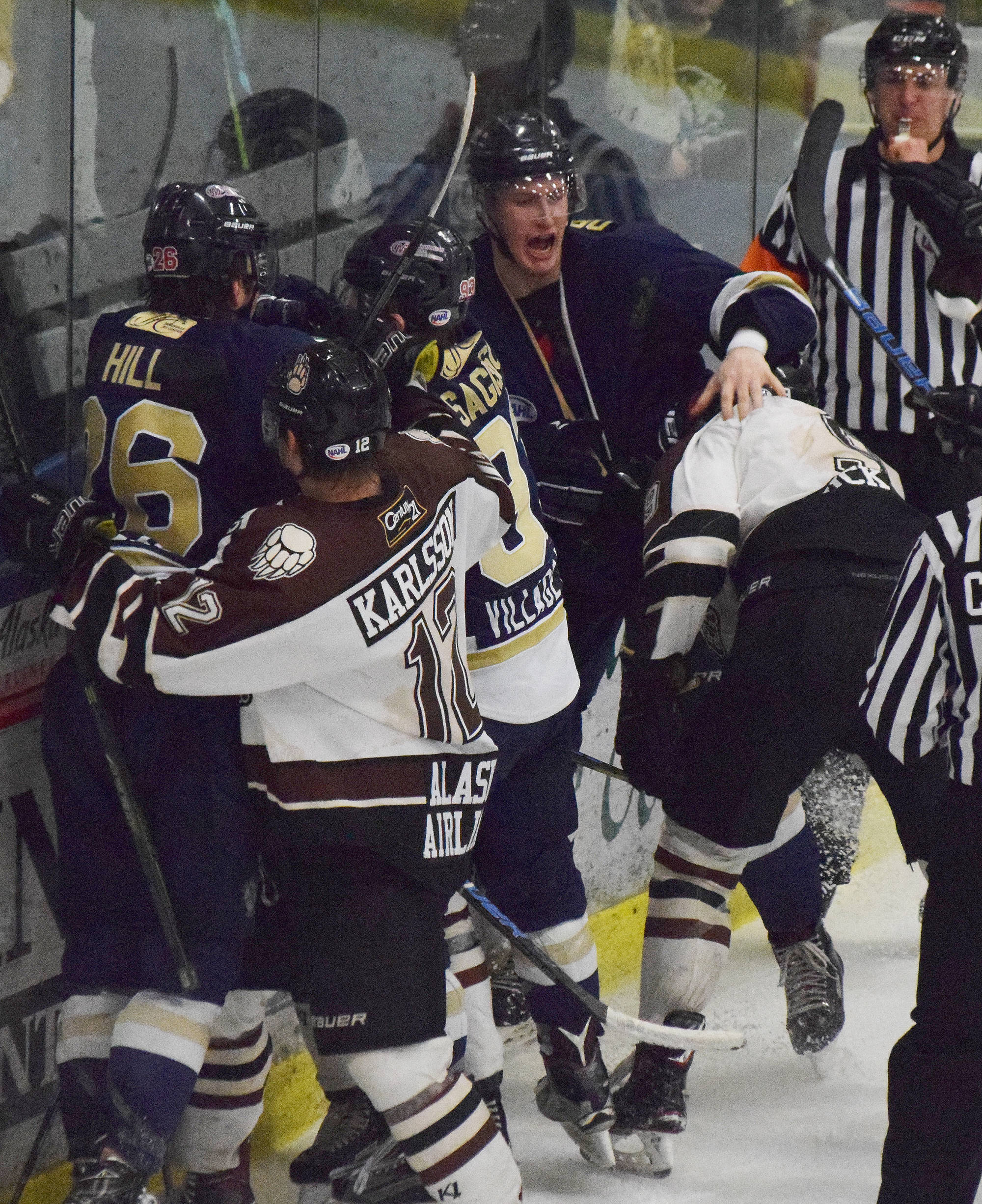 Janesville skater Sean Driscoll (middle) drops the gloves against Kenai River’s Alex Klekotka (right) Friday night at the Soldotna Regional Sports Complex. (Photo by Joey Klecka/Peninsula Clarion)