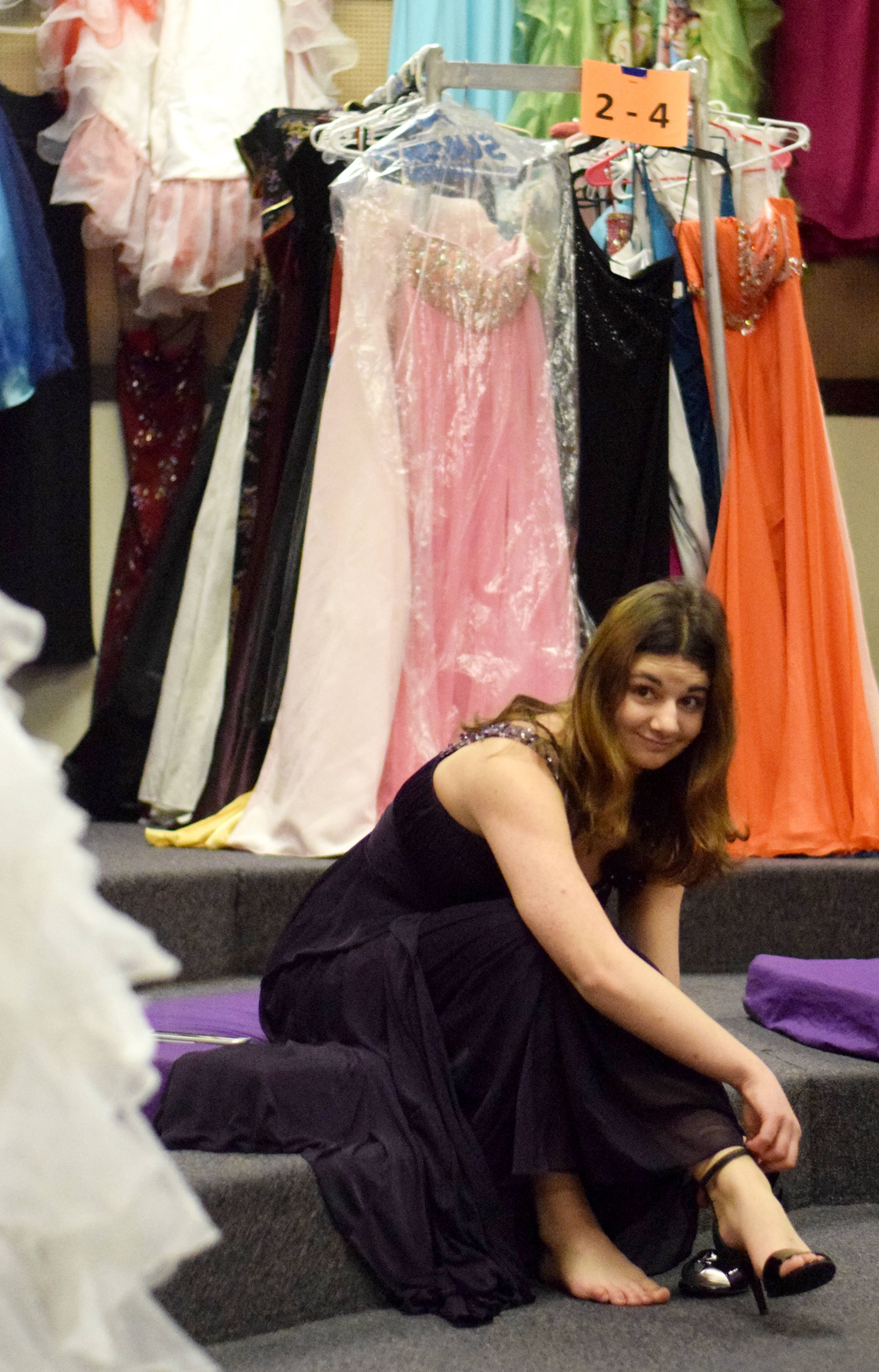 Nikiski High School junior Diana Narimanidze gives a look of approval Friday at Soldotna Prep School while trying on shoes to match a dress she found at Cinderella’s Closet, a program that provides free prom dresses and accessories to girls throughout the school district. (Photo by Kat Sorensen/Peninsula Clarion)