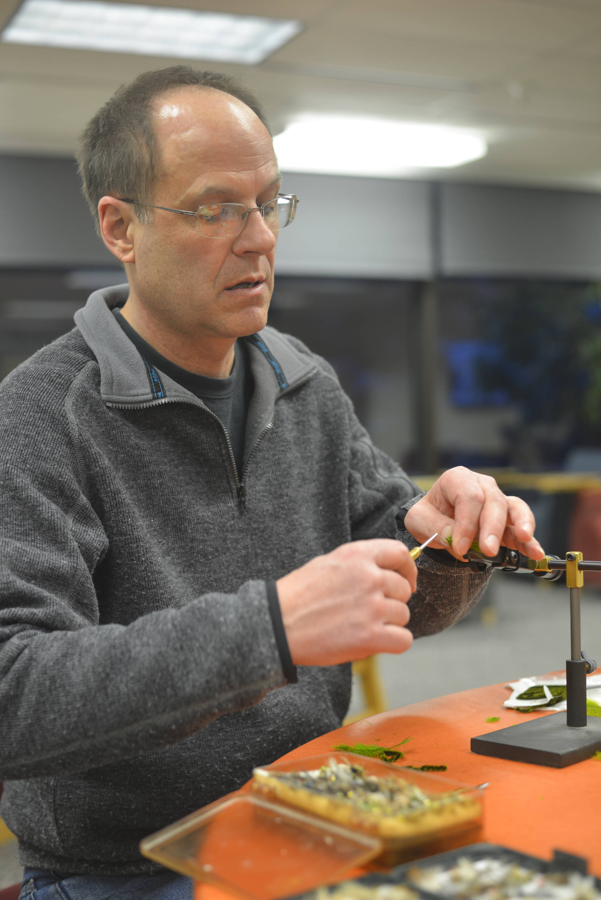 Dave Atcheson ties a fly for fly fishing at Kenai Peninsula College’s student service Thursday March 8 in Soldotna. Atcheson teaches a beginning fly fishing course at the college that is open to the public. Deadline for registration is March 19. (Photo by Kat Sorensen/Peninsula Clarion)