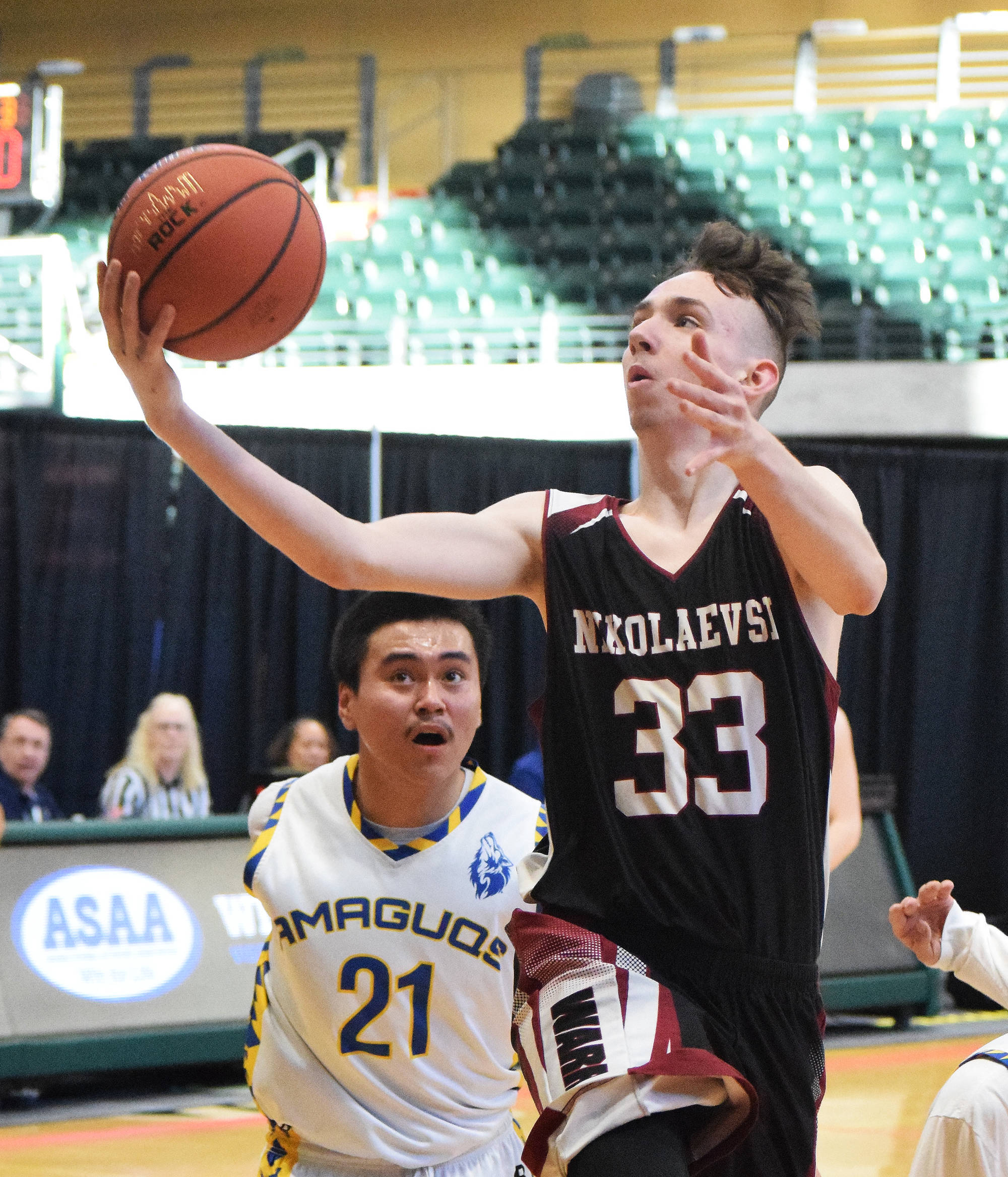 Nikolaevsk’s J.D. Mumey (33) rolls in a layup Thursday in a Class 1A state tournament quarterfinal against Nunamiut at the Alaska Airlines Center in Anchorage. (Photo by Joey Klecka/Peninsula Clarion)