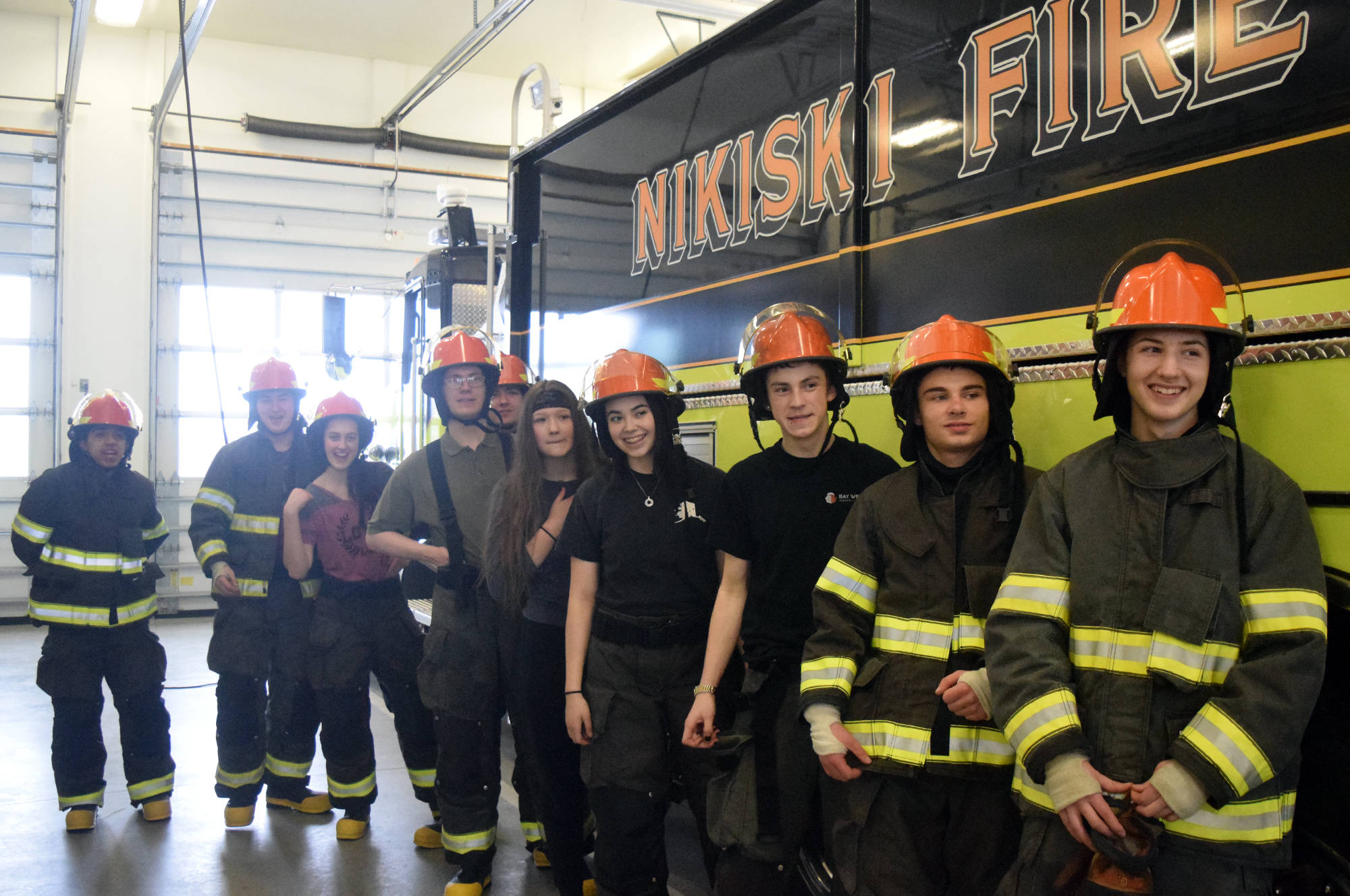 High school students from across the Kenai Peninsula Borough School District wrap up a day of training at Nikiski Fire Station. The group is part of the pilot program, basic firefighter academy, which included a week of training and culminates in the students becoming licensed by the state. (Photo by Kat Sorensen/Peninsula Clarion)