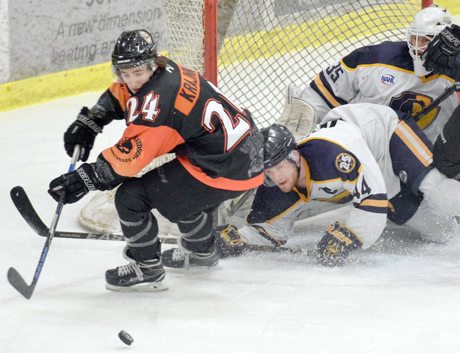 Kenai River Brown Bears forward Zach Krajnik tries to score late in the first period but is blocked by Springfield (Illinois) Jr. Blues defenseman Fletcher Fineman and goalie Evan Fear on Thursday, March 15, 2018, at the Soldotna Regional Sports Complex. (Photo by Jeff Helminiak/Peninsula Clarion)