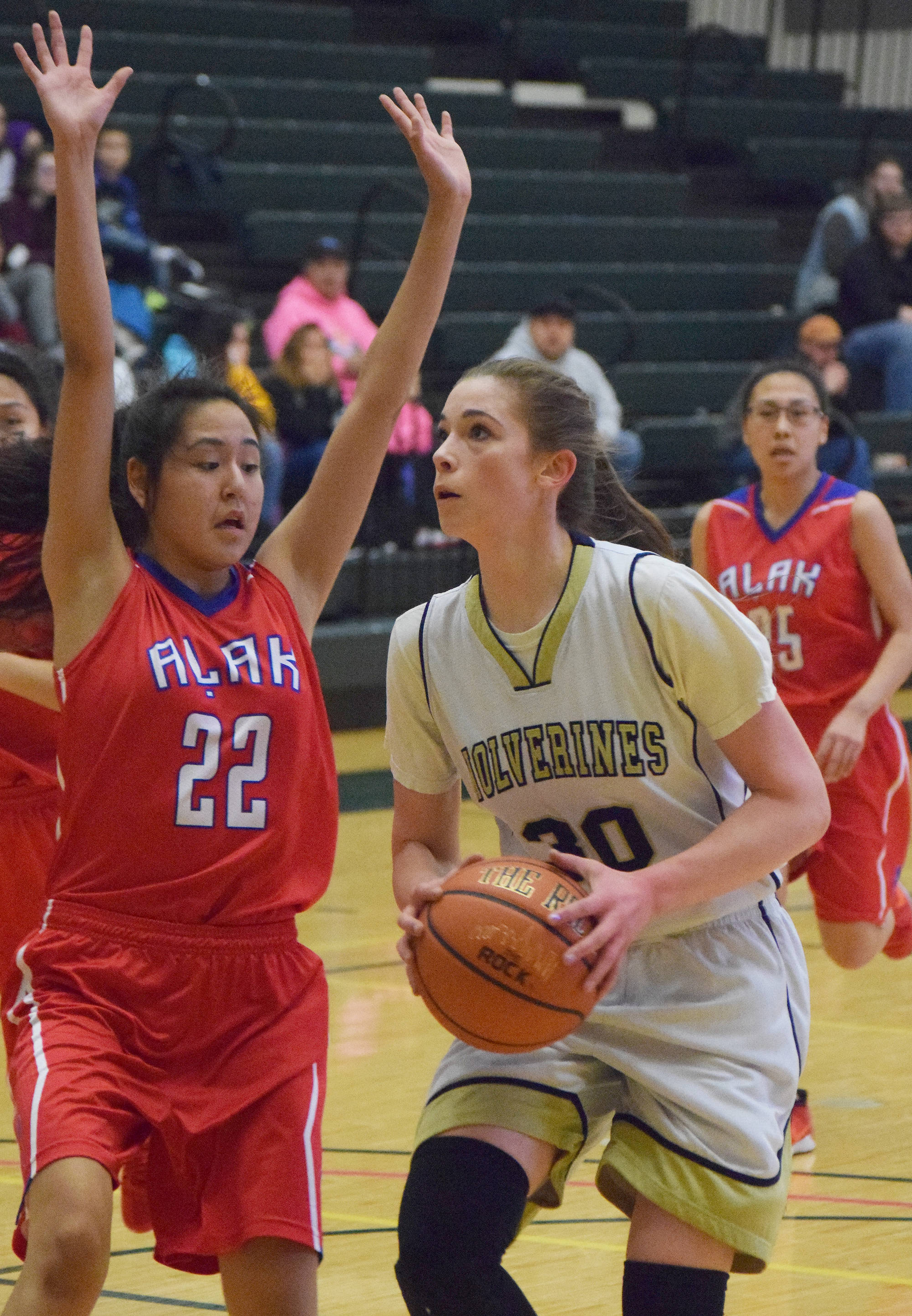 Ninilchik’s DeeAnn White looks for a shot against Alak’s Jenysa Ahmaogak (22) Thursday evening at the Class 1A state tournament at the Alaska Airlines Center in Anchorage. (Photo by Joey Klecka/Peninsula Clarion)