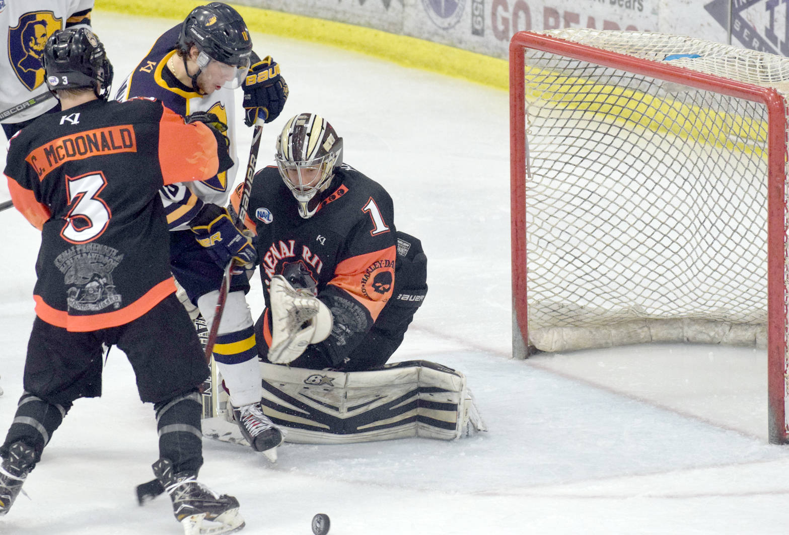 Kenai River Brown Bears defenseman Cam McDonald and goalie Gavin Enright combine to keep Springfield (Illinois) Jr. Blues forward Max Brainin from scoring Friday, March 16, 2018, at the Soldotna Regional Sports Complex. (Photo by Jeff Helminiak/Peninsula Clarion)