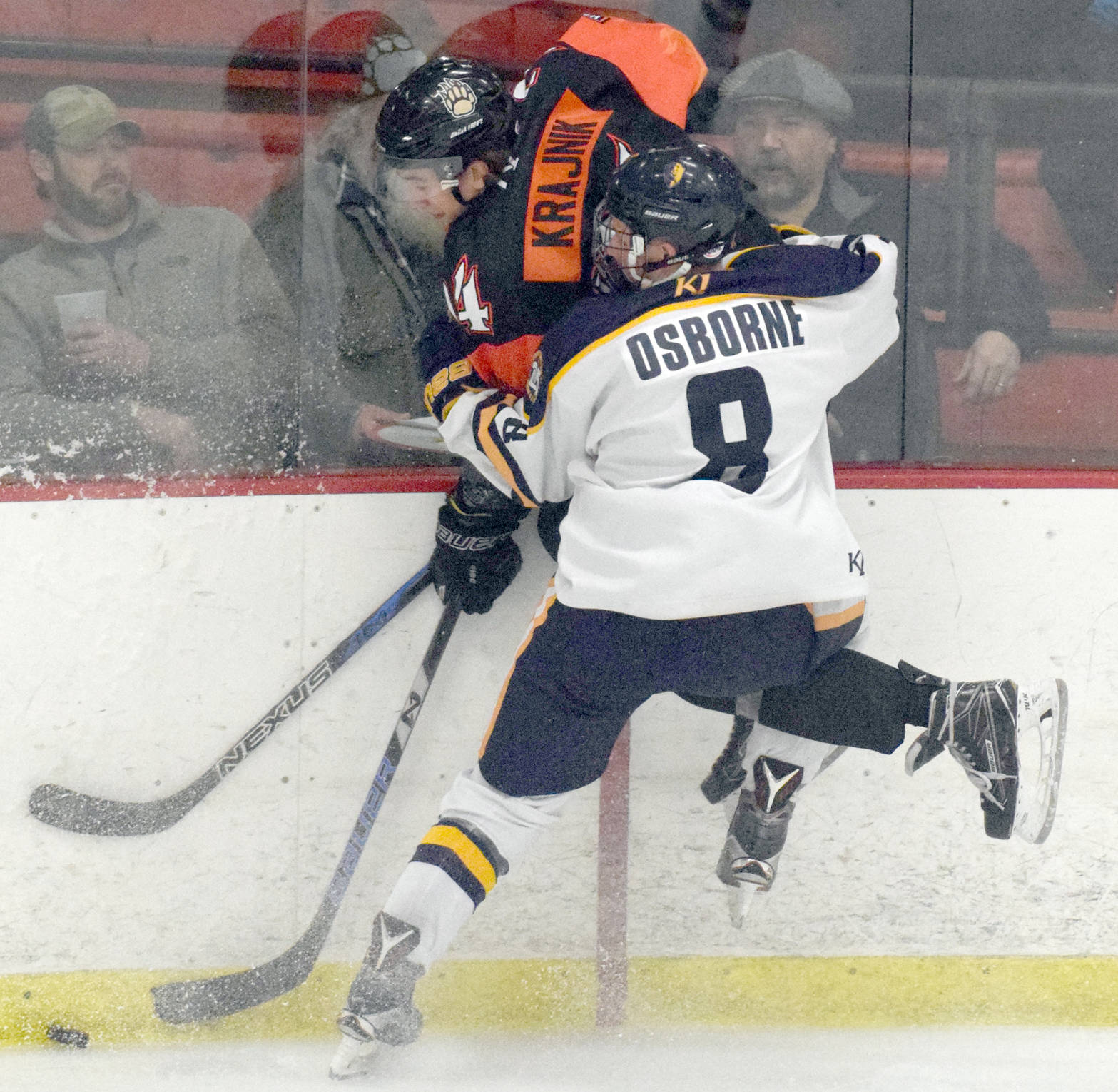 Kenai River Brown Bears forward Zach Krajnik gets pasted into the boards by Springfield (Illinois) defenseman Max Osborne on Friday, March 16, 2018, at the Soldotna Regional Sports Complex. (Photo by Jeff Helminiak/Peninsula Clarion)